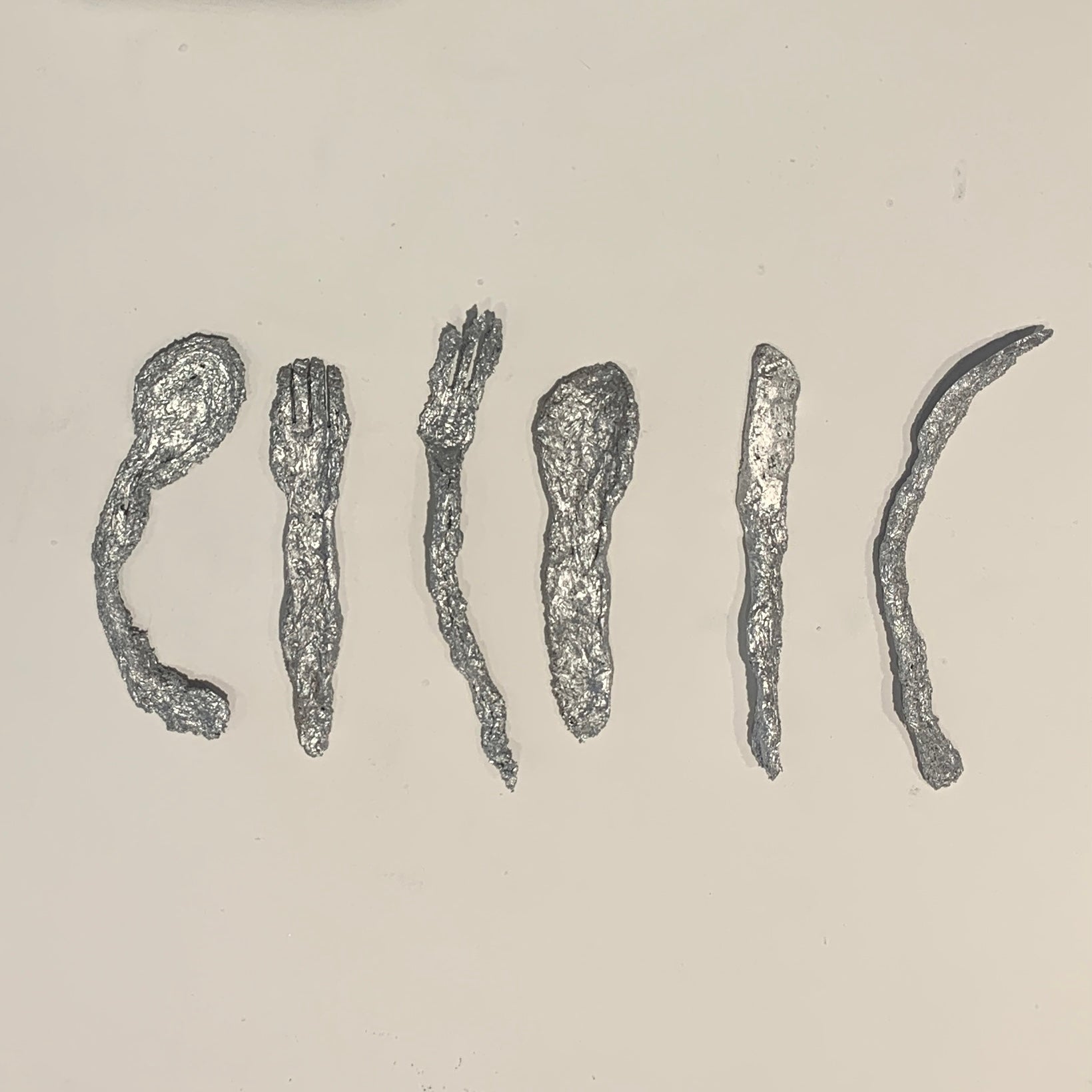a series of six pieces of assorted cutlery made of cast knotweed powder and electroplated with silver