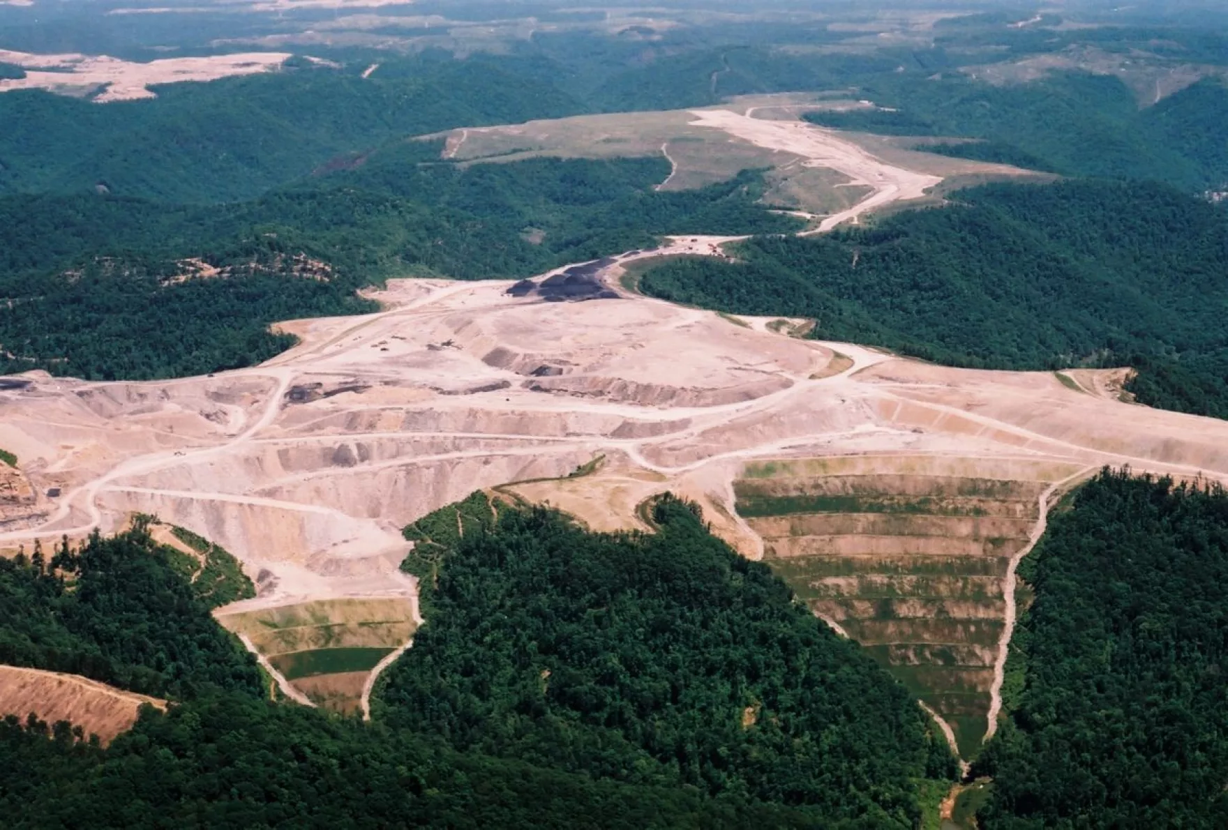Mountain top leveled for coal mining with terraced valley fills