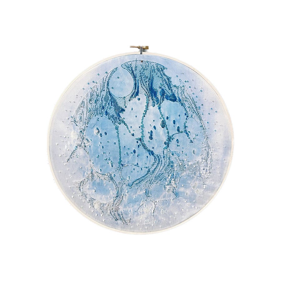 On a round piece of silk dyed light blue by the cyanotype, I made some patterns like the moon sea by embroidery.