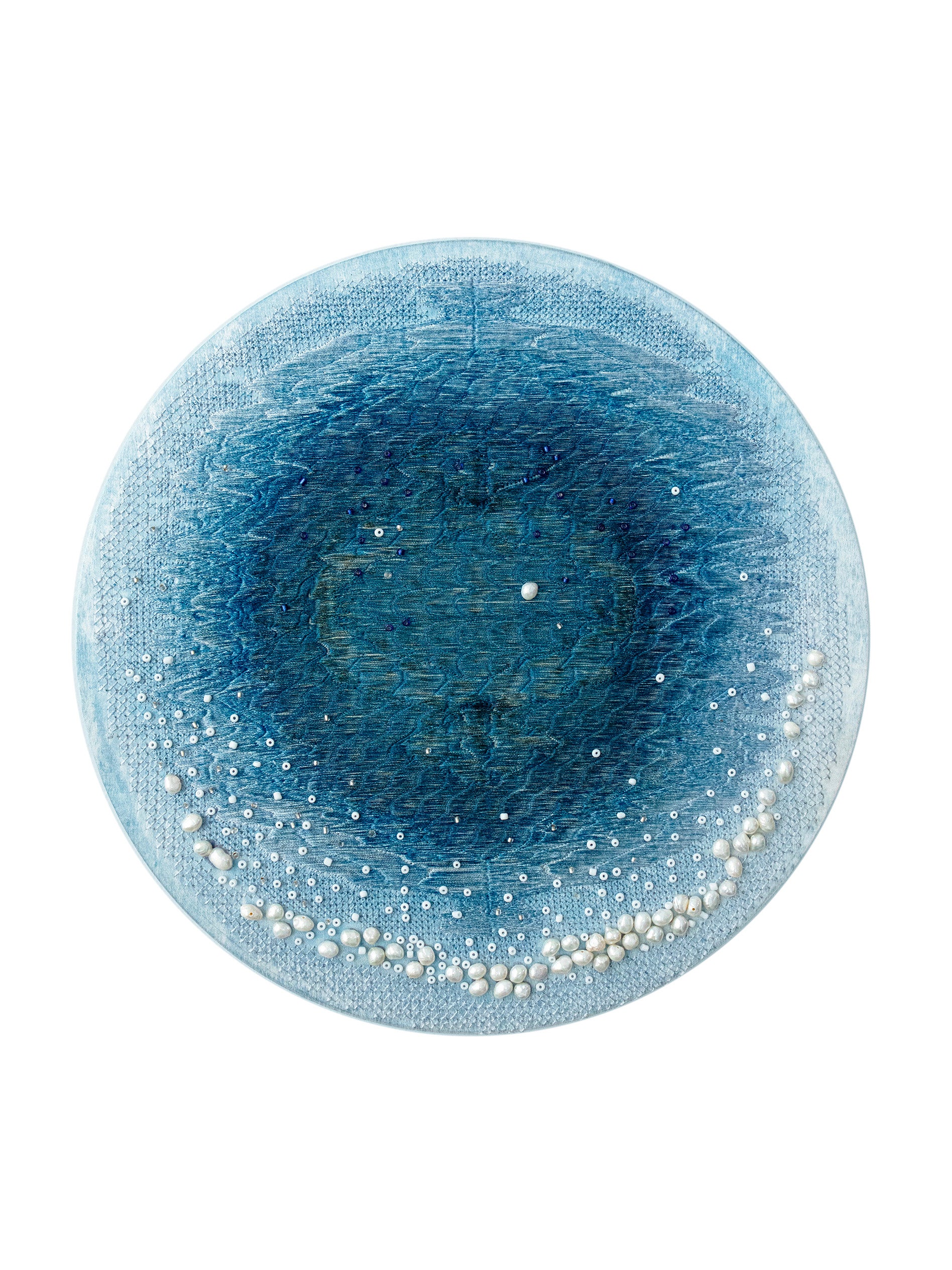 On a silk dyed light blue, I used embroidery and beadwork to create a pattern similar to the blue hole of the ocean.
