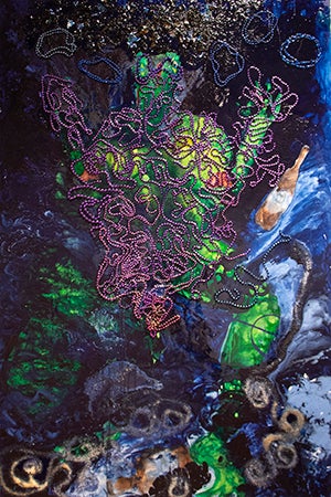 Alligator Figure surrounded by Mardi Gras beads and voodoo symbols