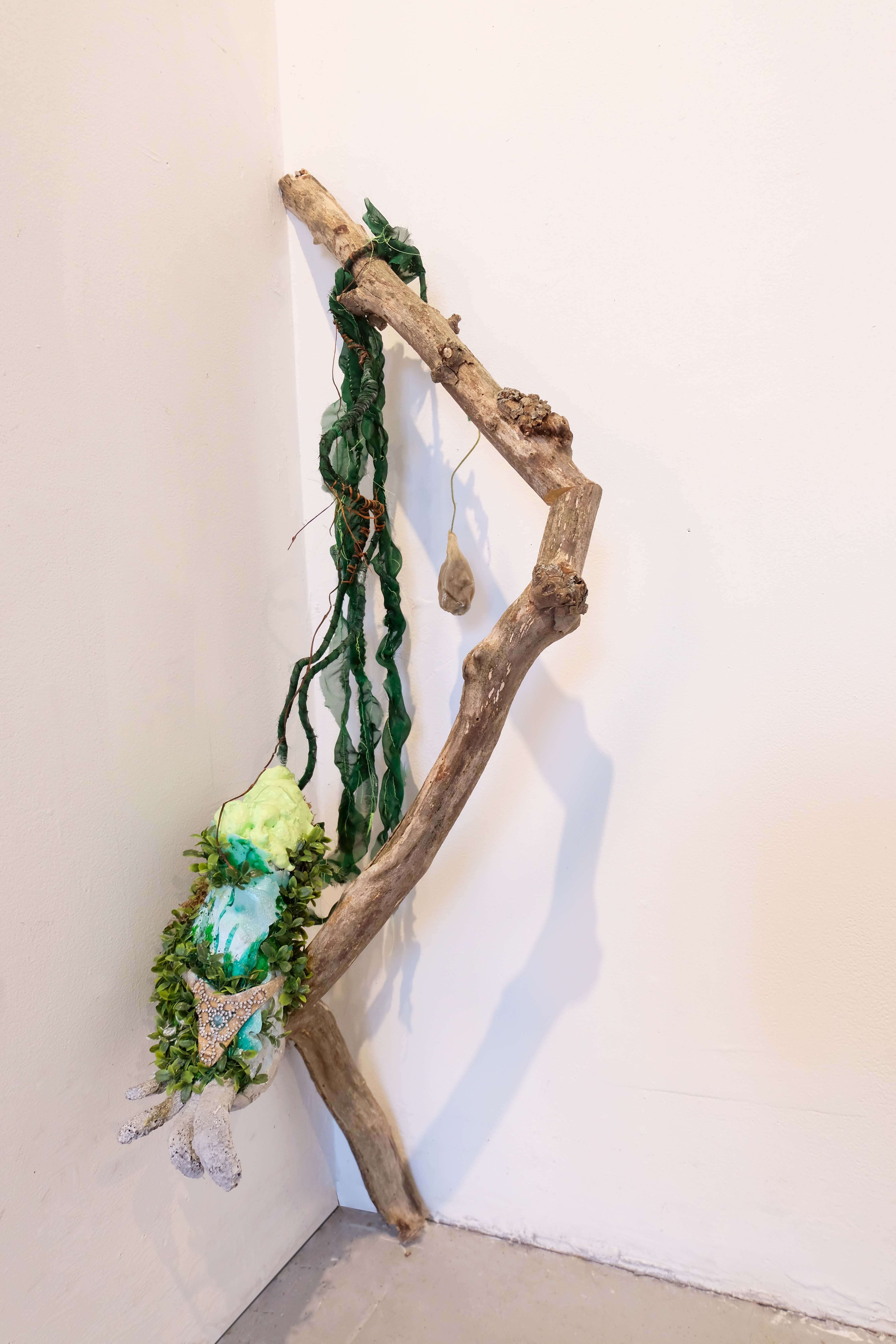 2023. Tree branch, shoe, foam epoxy, artificial plant, chiffon fabric, Aleppo soap.
