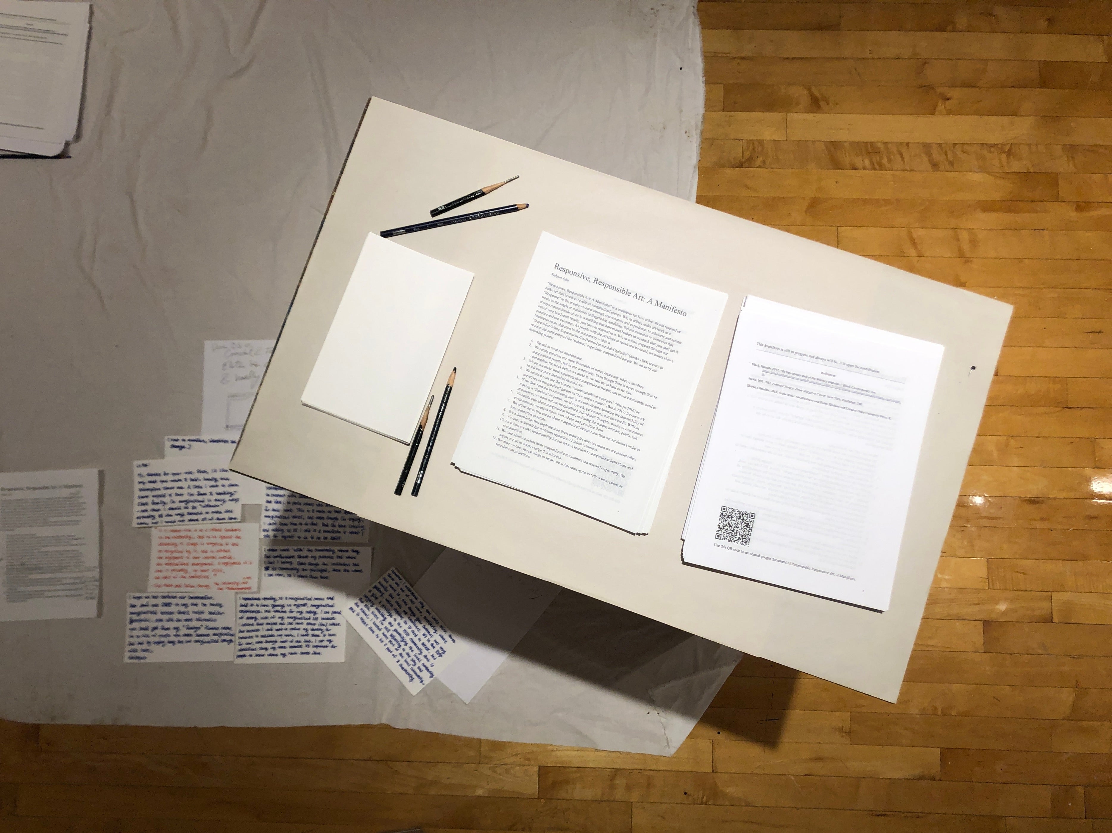 Two pages of “Responsive, Responsible Art: A Manifesto” displayed in a Google Doc. The left page shows a title, introduction paragraph, and a list of guidlines, while the right page presents references and a QR code for reader contributions. All text is black on a white background, except for a link to an article on the reference list.