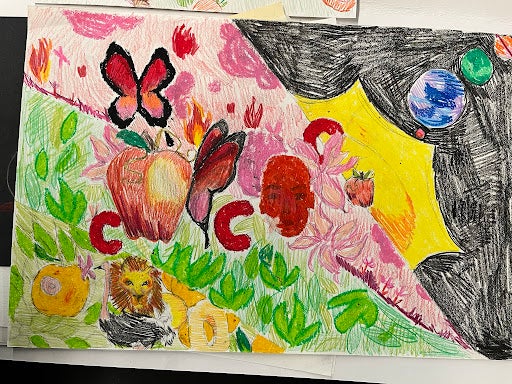 Vividly colored oil pastel and colored pencil drawing depicting the solar system, a red face in front of a pink face, two butterflies, one perched on an apple, a second smaller apple, flames, flowers, green leaves, red “c” shapes, a yellow lion next to an ostrich, and yellow fruit.