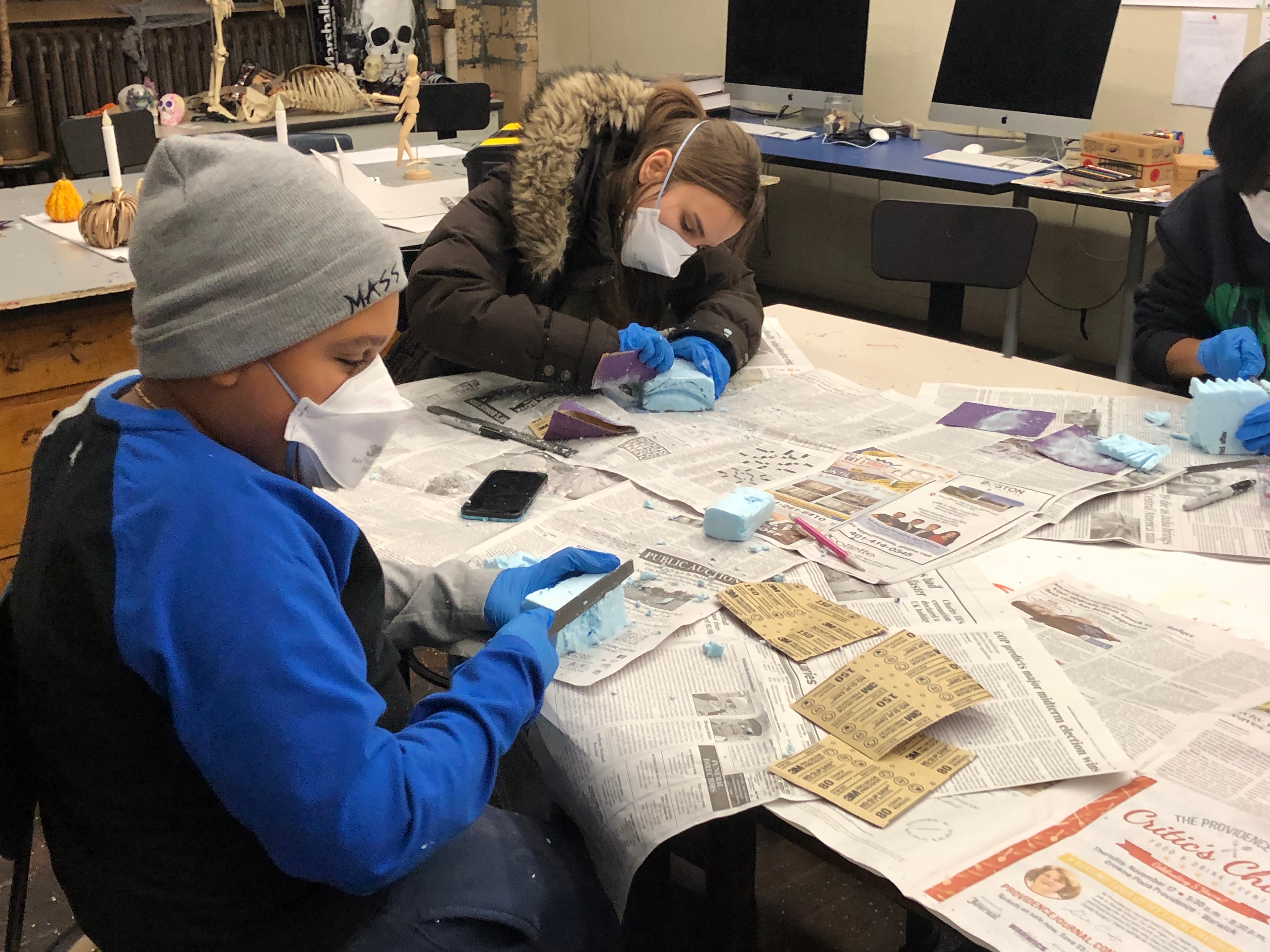 Students Benny and Sophia working with blue foam.