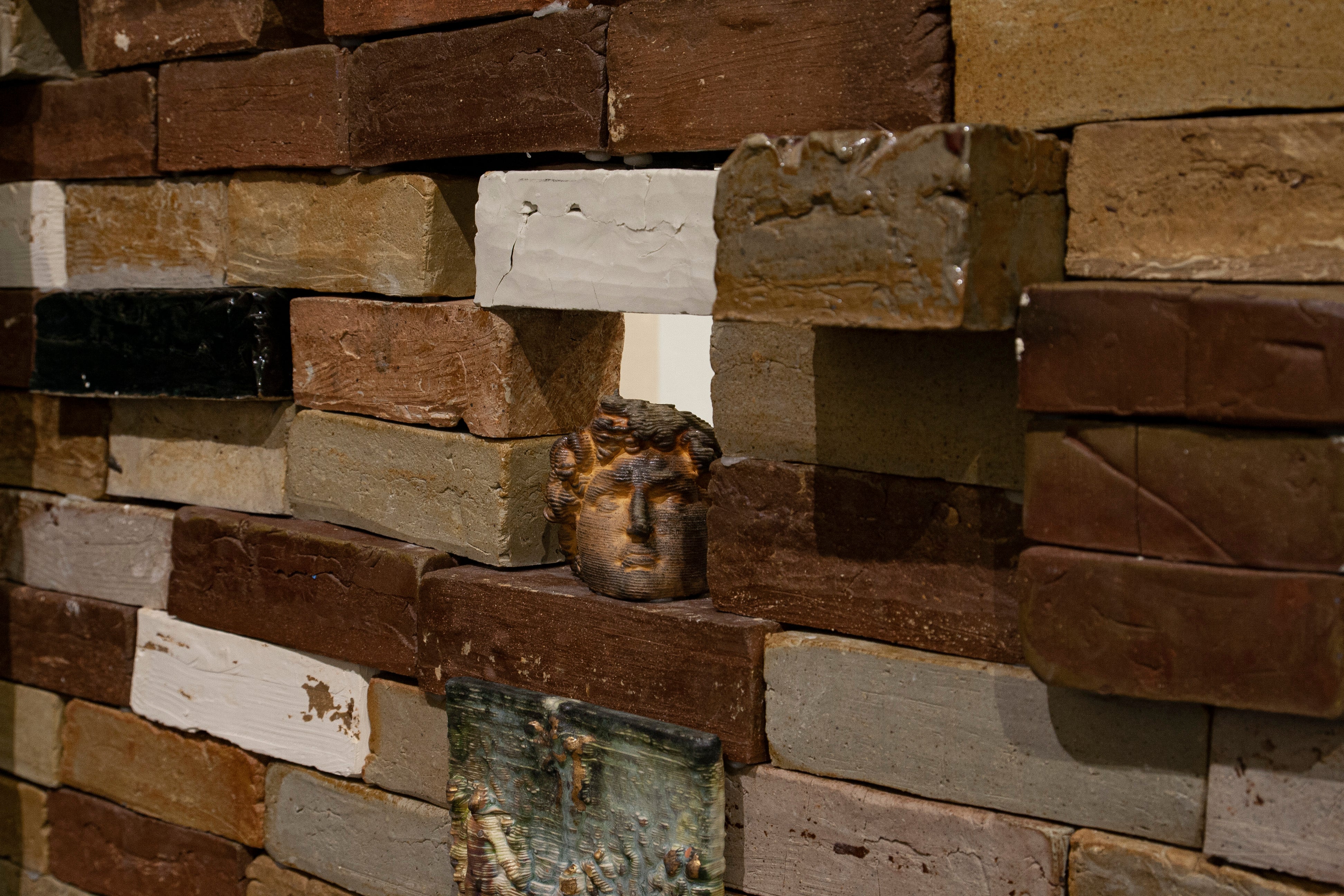 close up of brick wall filled with small objects printed from historical scans