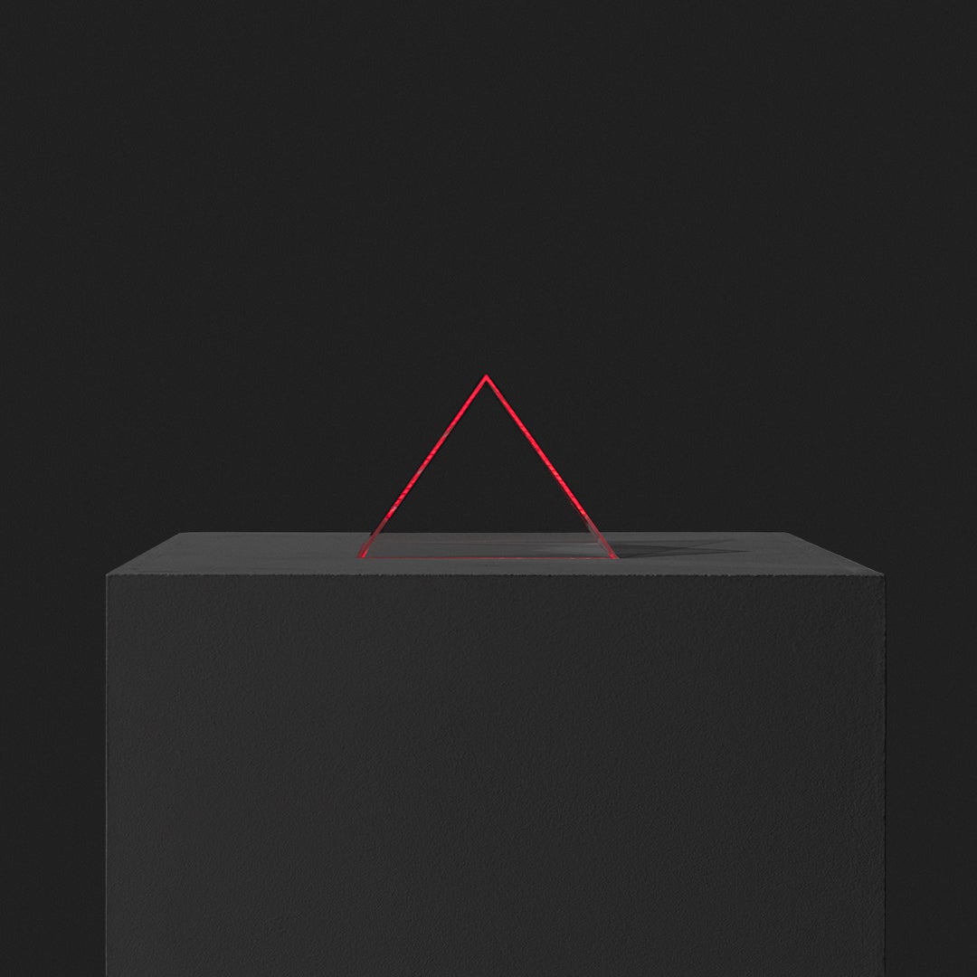 A transparent pyramid glows with its surrounding sound.