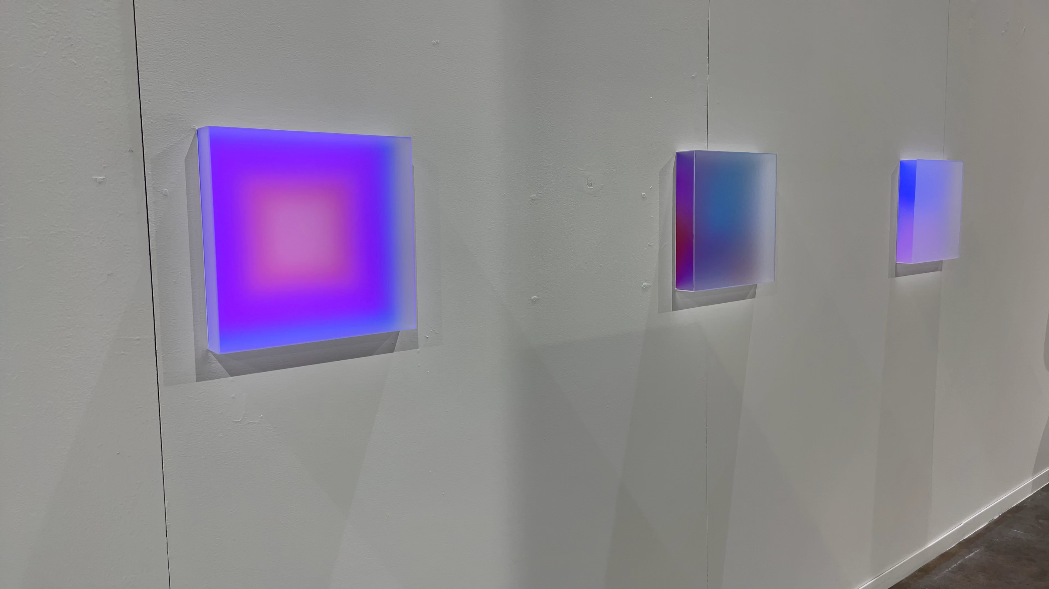 Photo documentation of installation featuring a close-up of three light boxes.