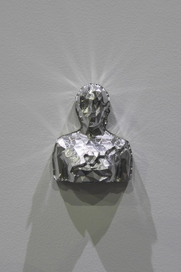 A detail shot of multiple sculptures on individual shelves