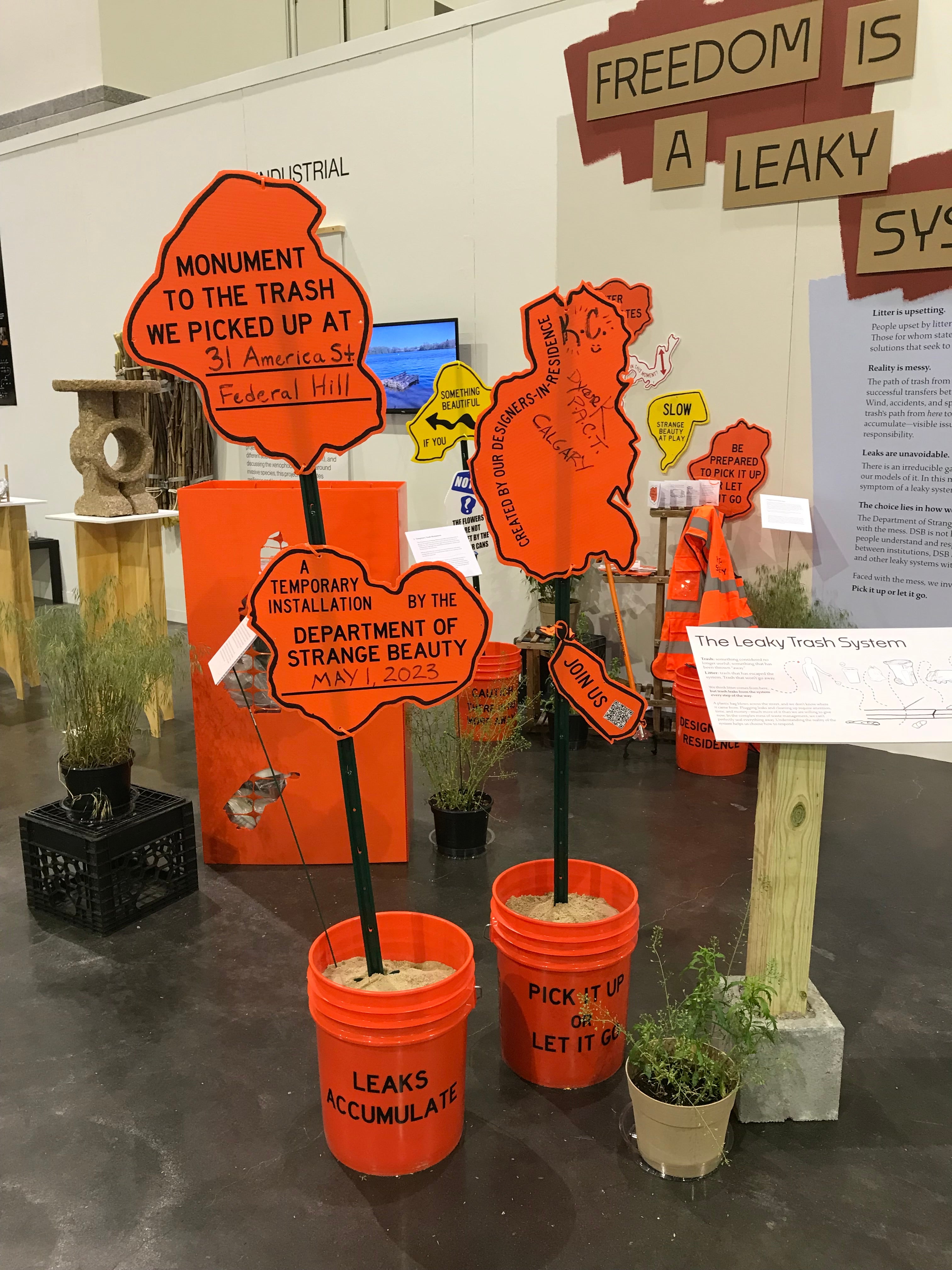 Installation view of signs from the Temporary Trash Monument Kit