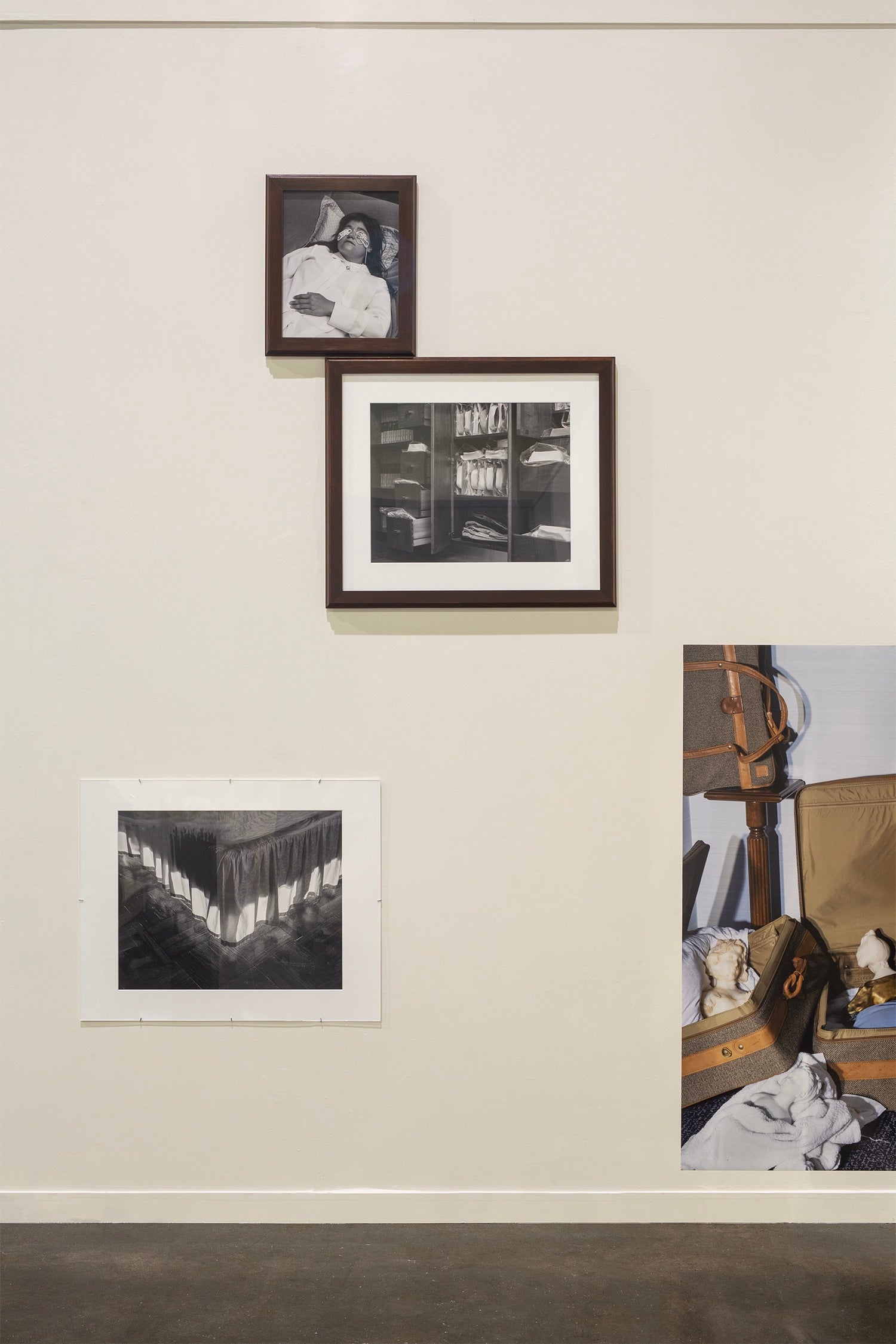 .Arrangement of four photographs on gallery wall.