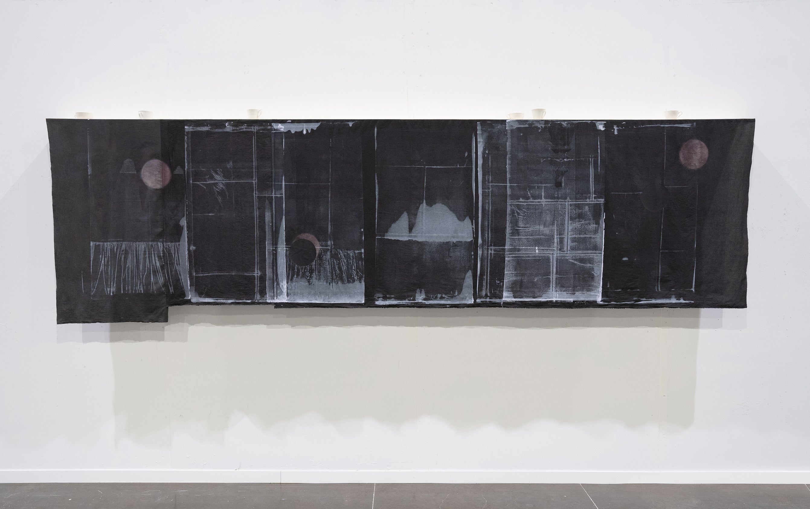 length of printed black fabric with faded windows and moons