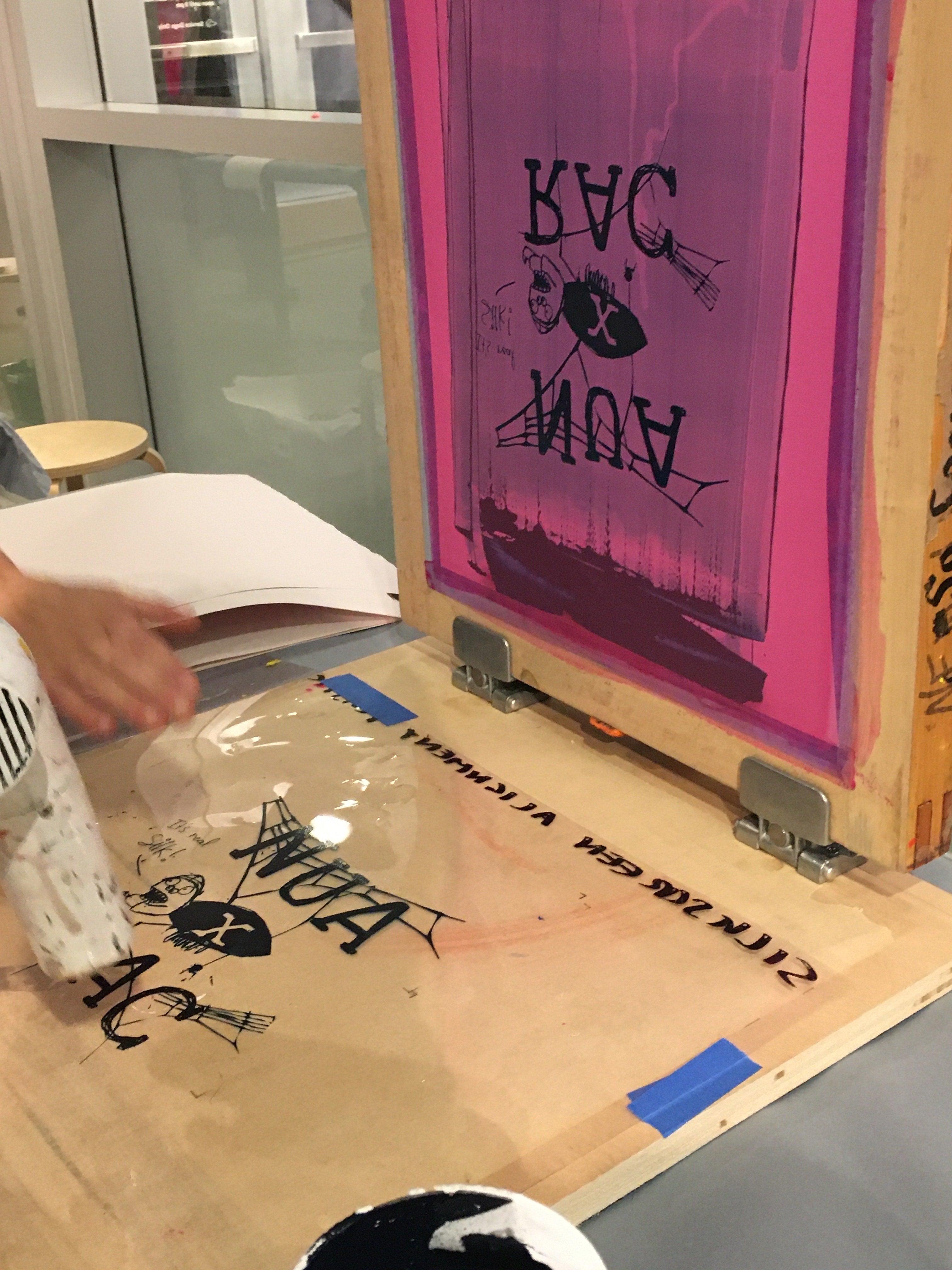 Screen printing screen with a design that featured NUA (New Urban Arts) and RAC (RISD Art Circle) with a small spider