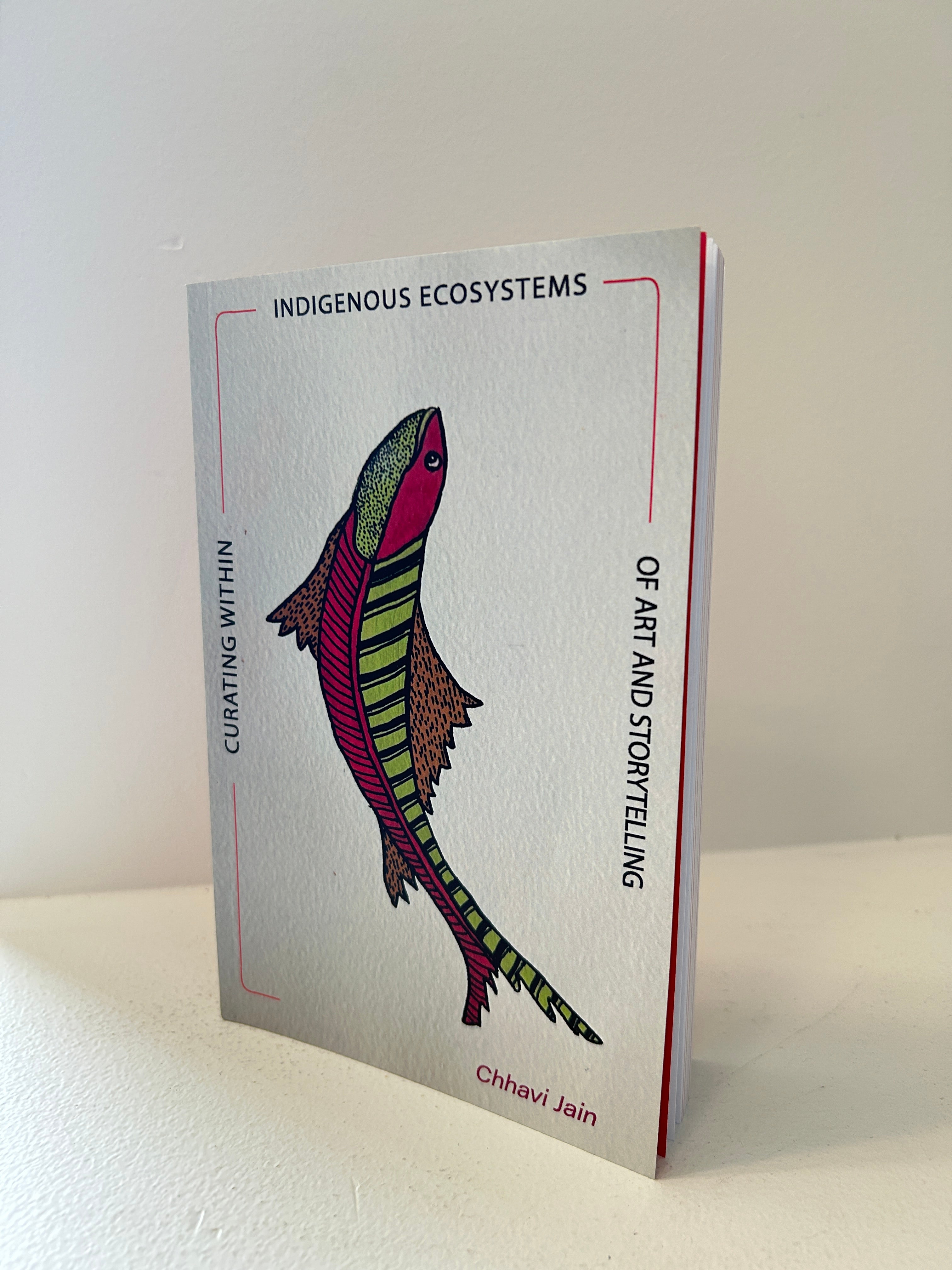 Image of the Book featuring an artwork- pink and green fish looking upwards.