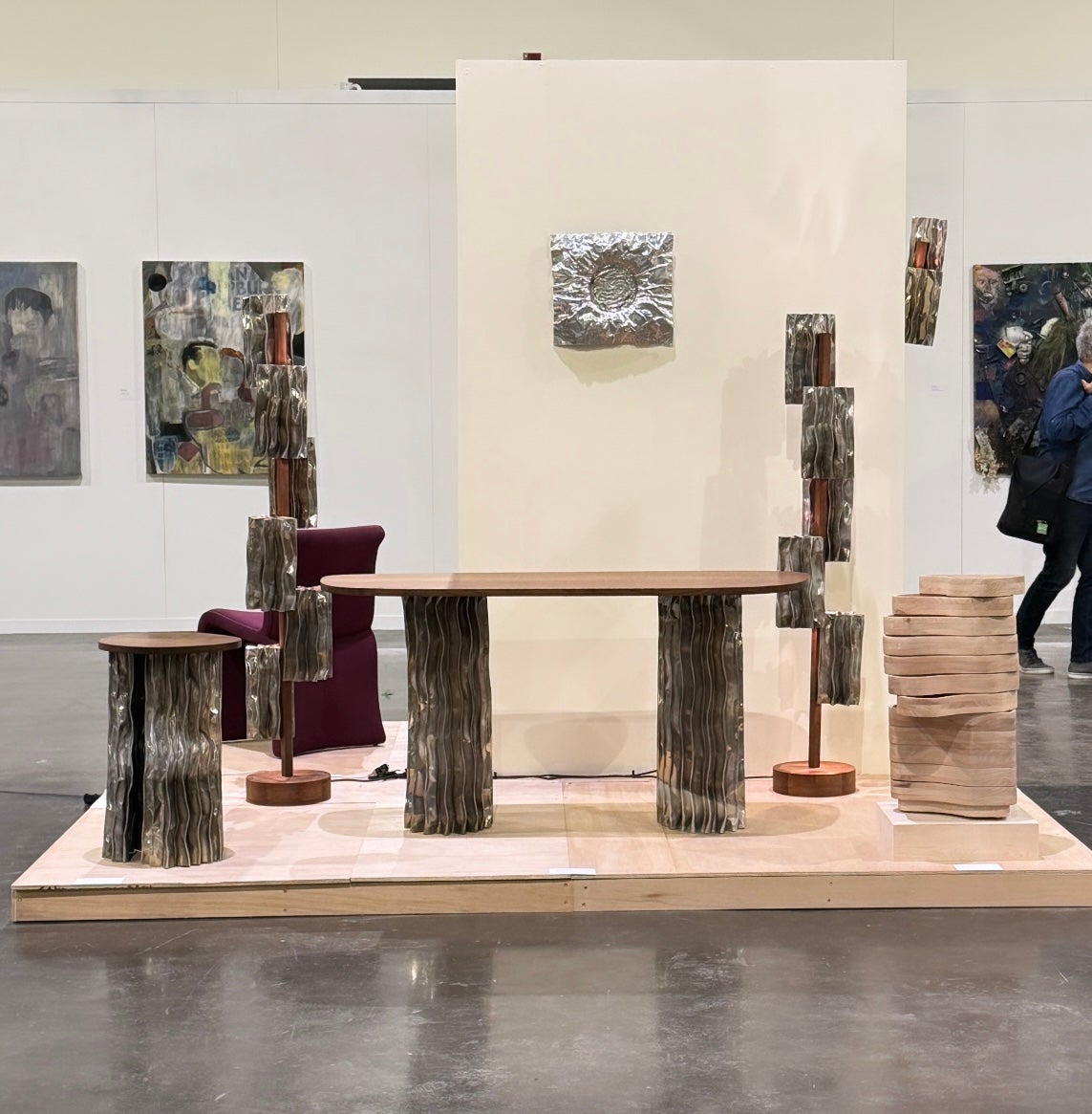 A modern furniture collection includes a coffee table, console table, pedestal table, and two floor lamps. The tables have an aluminum base and walnut tops. The floor lamps display decorative aluminum shades and central walnut stands.