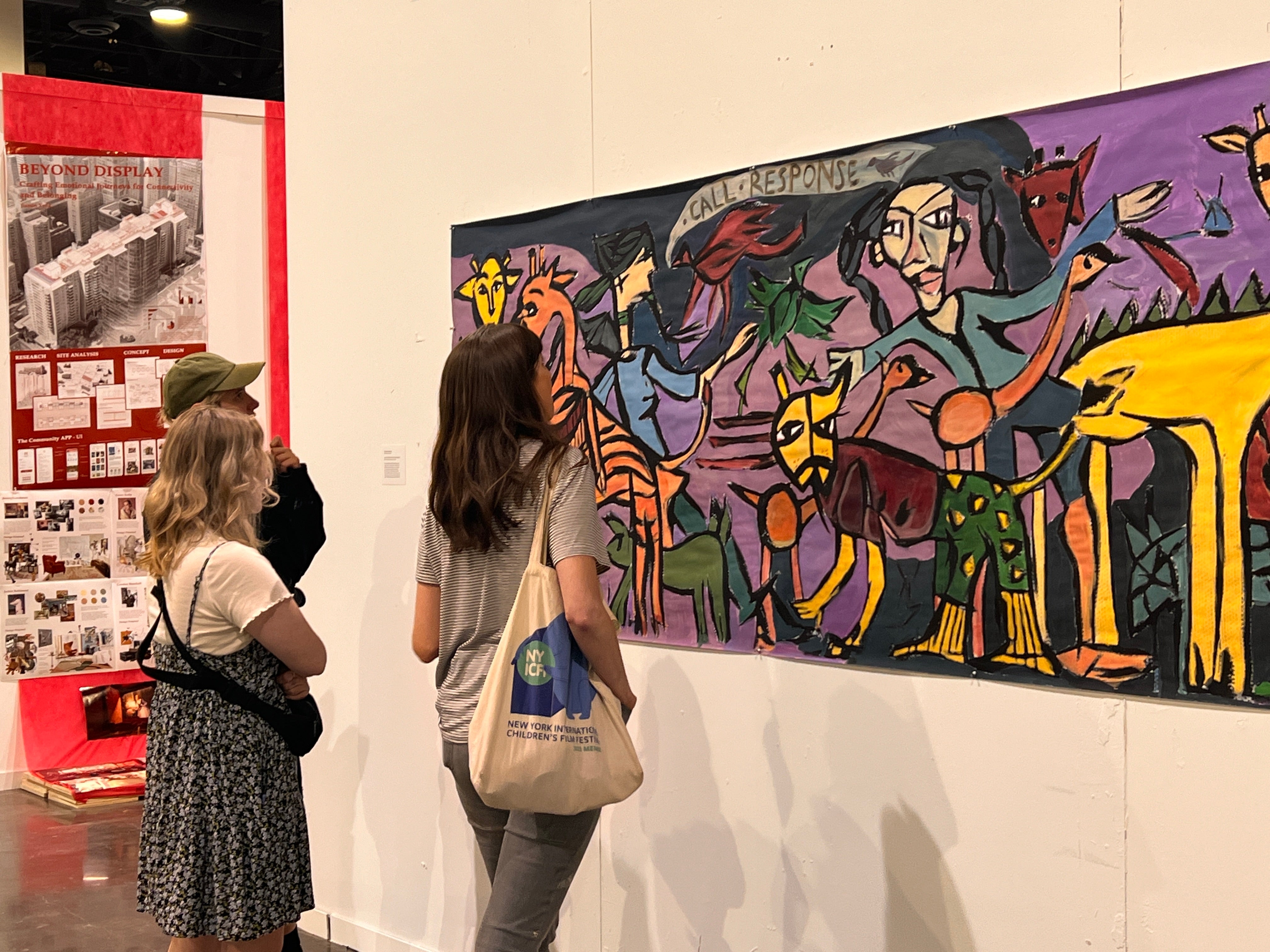two individuals looking at a painting