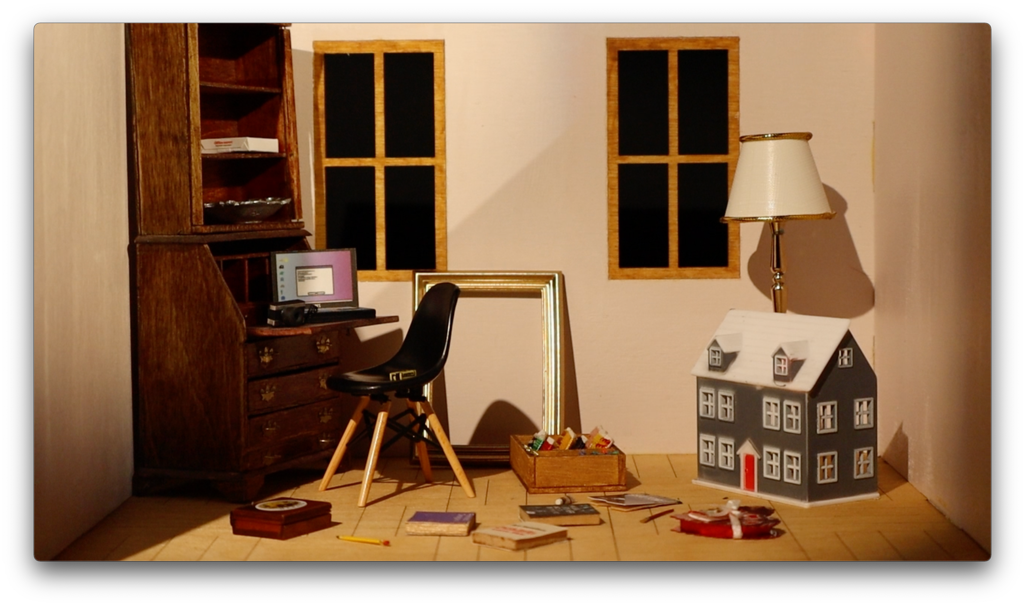/Film%20still%20of%20a%20miniature%20pink%20room%20with%20a%20desk%2C%20chair%2C%20dollhouse%2C%20golden%20frame%2C%20and%20a%20number%20of%20books%20across%20the%20floor.