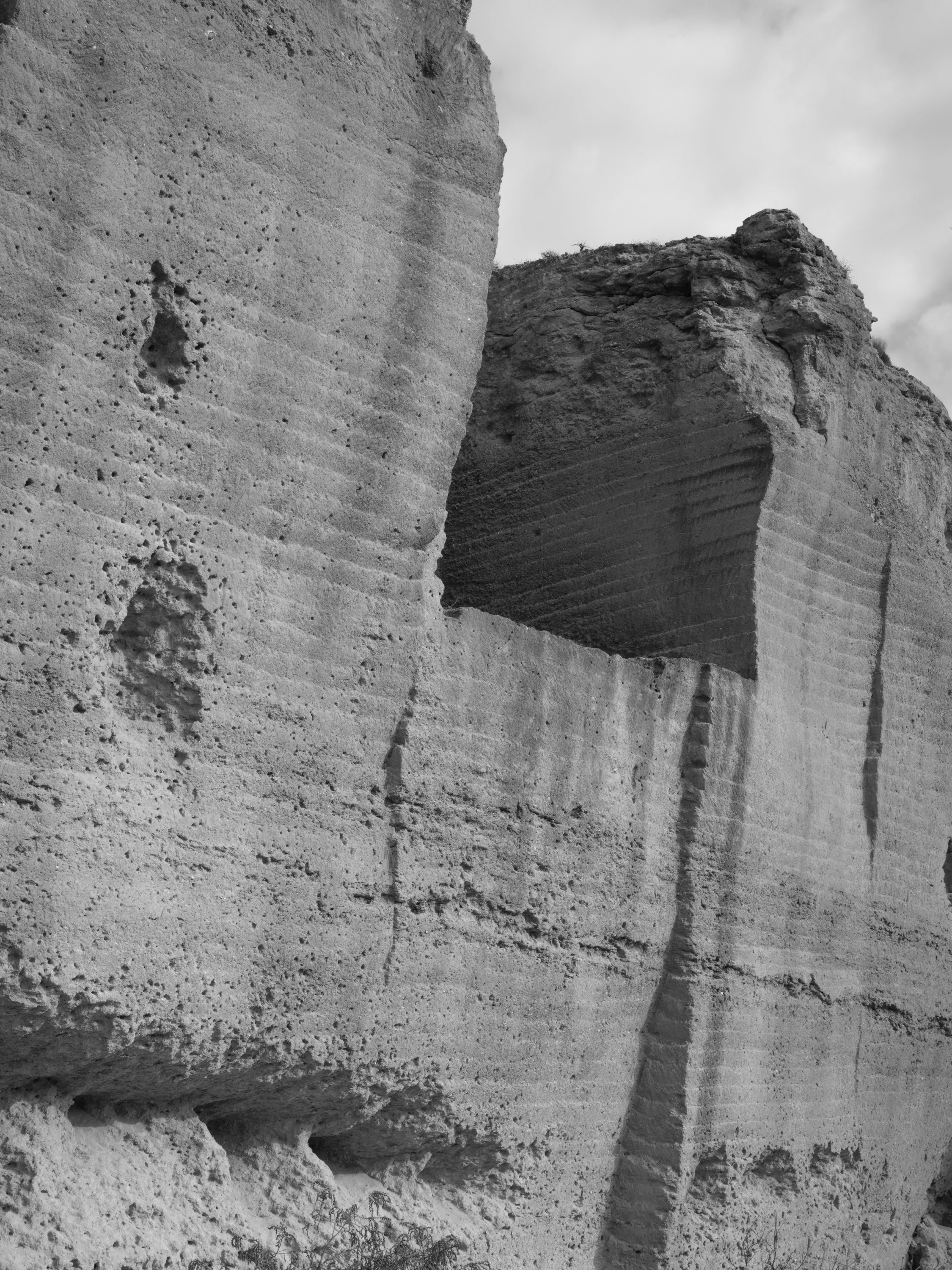 /Black%20and%20white%20photograph%20of%20a%20quarry%20in%20Spain%2C%20with%20holes%20that%20seem%20erosion%2C%20but%20that%20are%20made%20because%20of%20bullets.%20The%20police%20used%20the%20space%20as%20a%20practice%20shooting%20field
