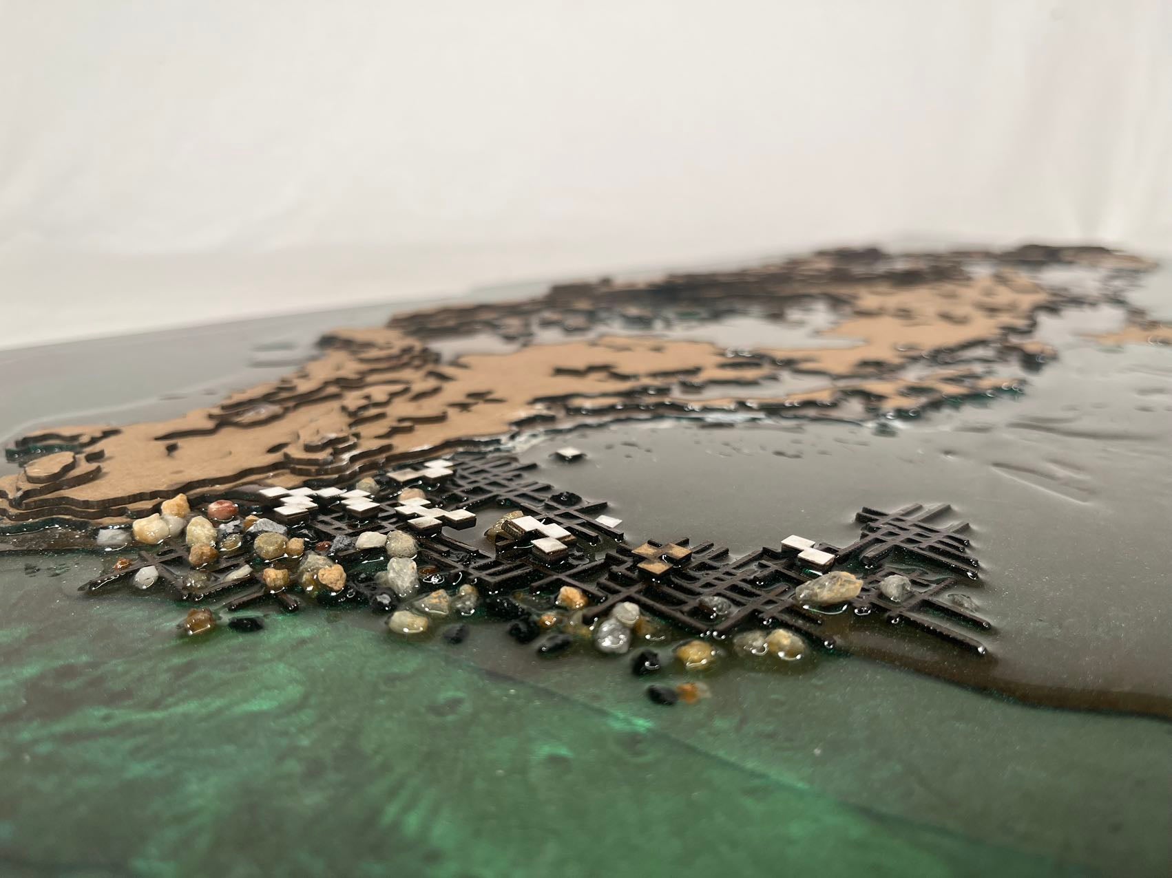 /A%20model%20made%20of%20clipboard%20and%20resin%20showing%20the%20physical%20relationship%20between%20original%20island%20and%20future%20construction.