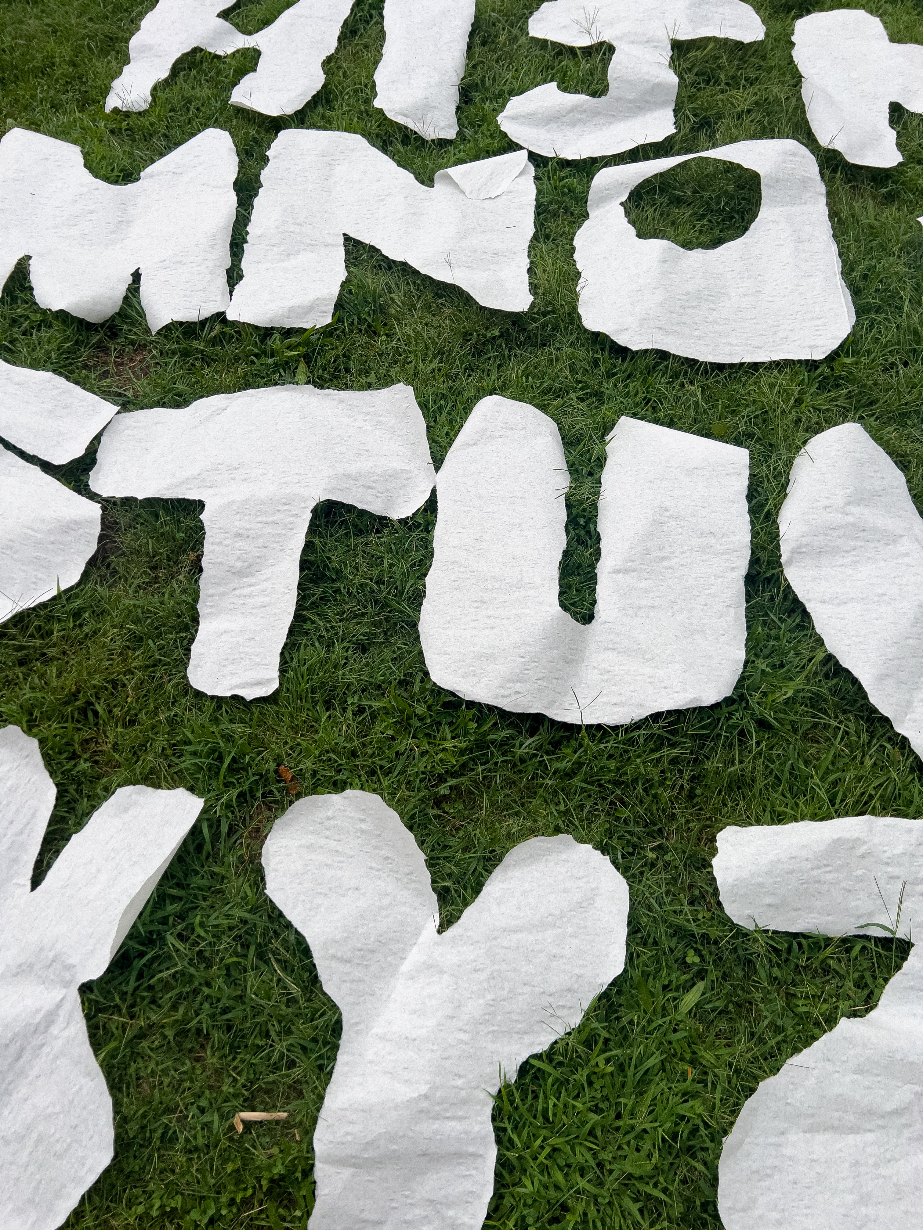 /A%20photo%20of%20large%20letters%20of%20the%20alphabet%20lying%20on%20green%20grass.