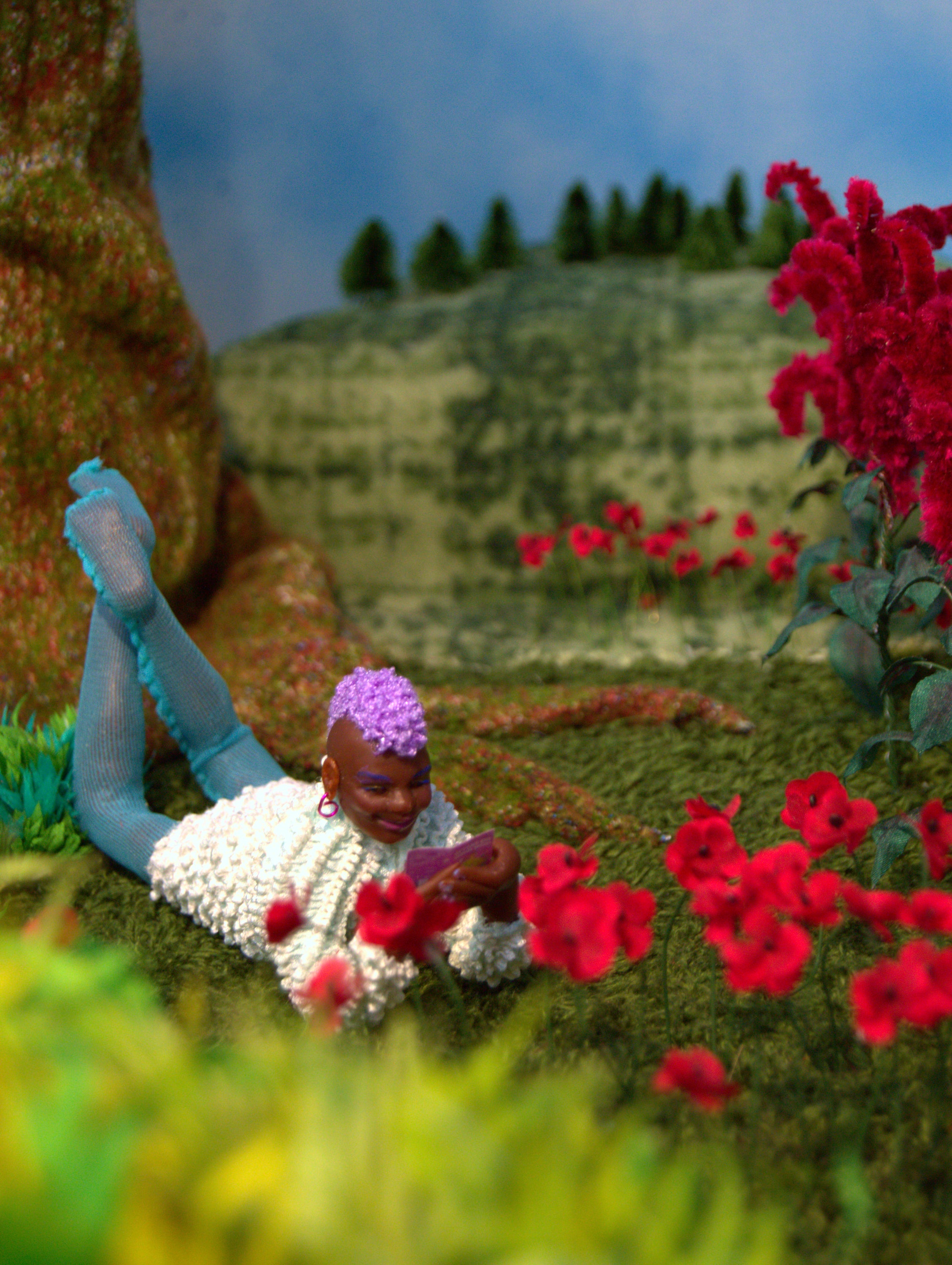 /A%20smiling%20figure%20reads%20%22Beyond%20the%20Gender%20Binary%22%20in%20a%20grassy%20garden%20under%20a%20partially%20cloudy%20blue%20sky