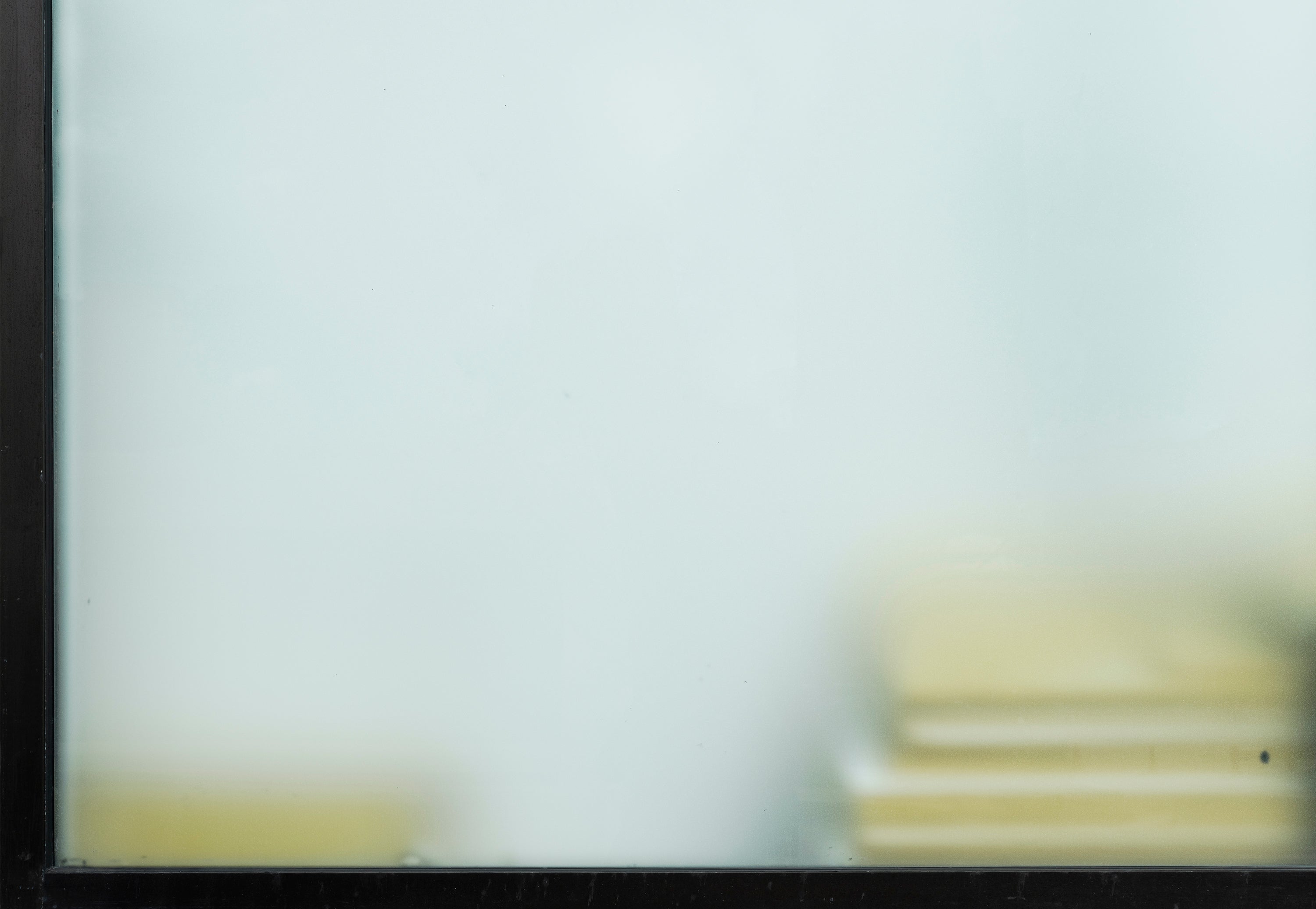 /A%20window%20from%20an%20office%20with%20yellow%20documents%20stack.
