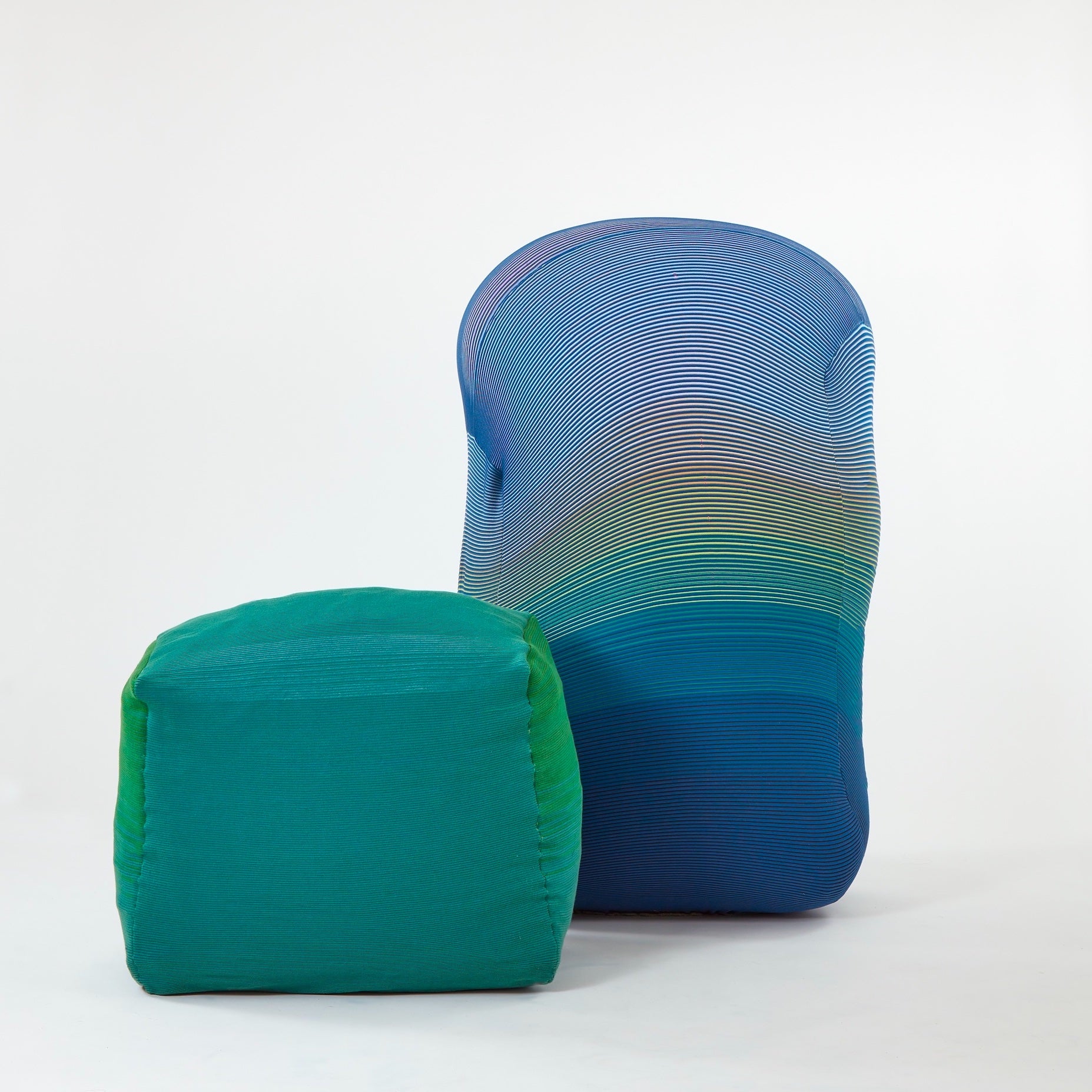 /A%20cushioned%20bench%20covered%20in%20green%20wool%20knit%20sits%20on%20the%20left%20side.%20A%20blue%20inflated%20Knit%20Wiggle%20wall%20sits%20next%20to%20it.