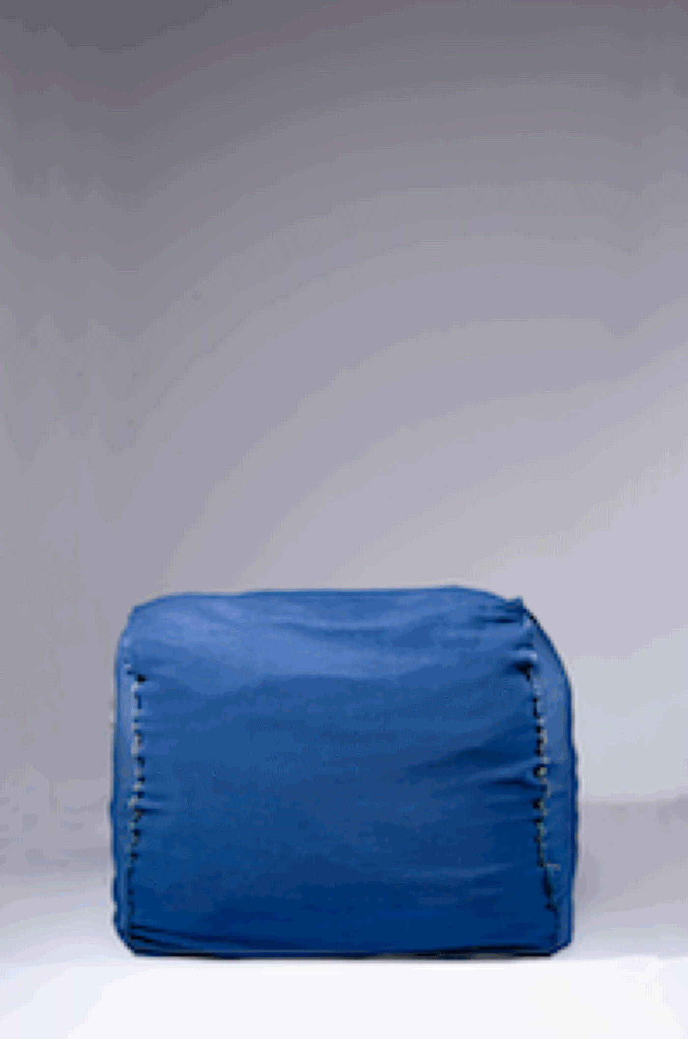 /Knit%20Wiggle%20is%20an%20inconspicuous%20blue%20cushioned%20bench.%20As%20it%20inflates%20to%20become%20a%20wall%20with%20curvy%20side%20profiles%2C%20stripes%20with%20subtle%20color%20variations%20are%20revealed.