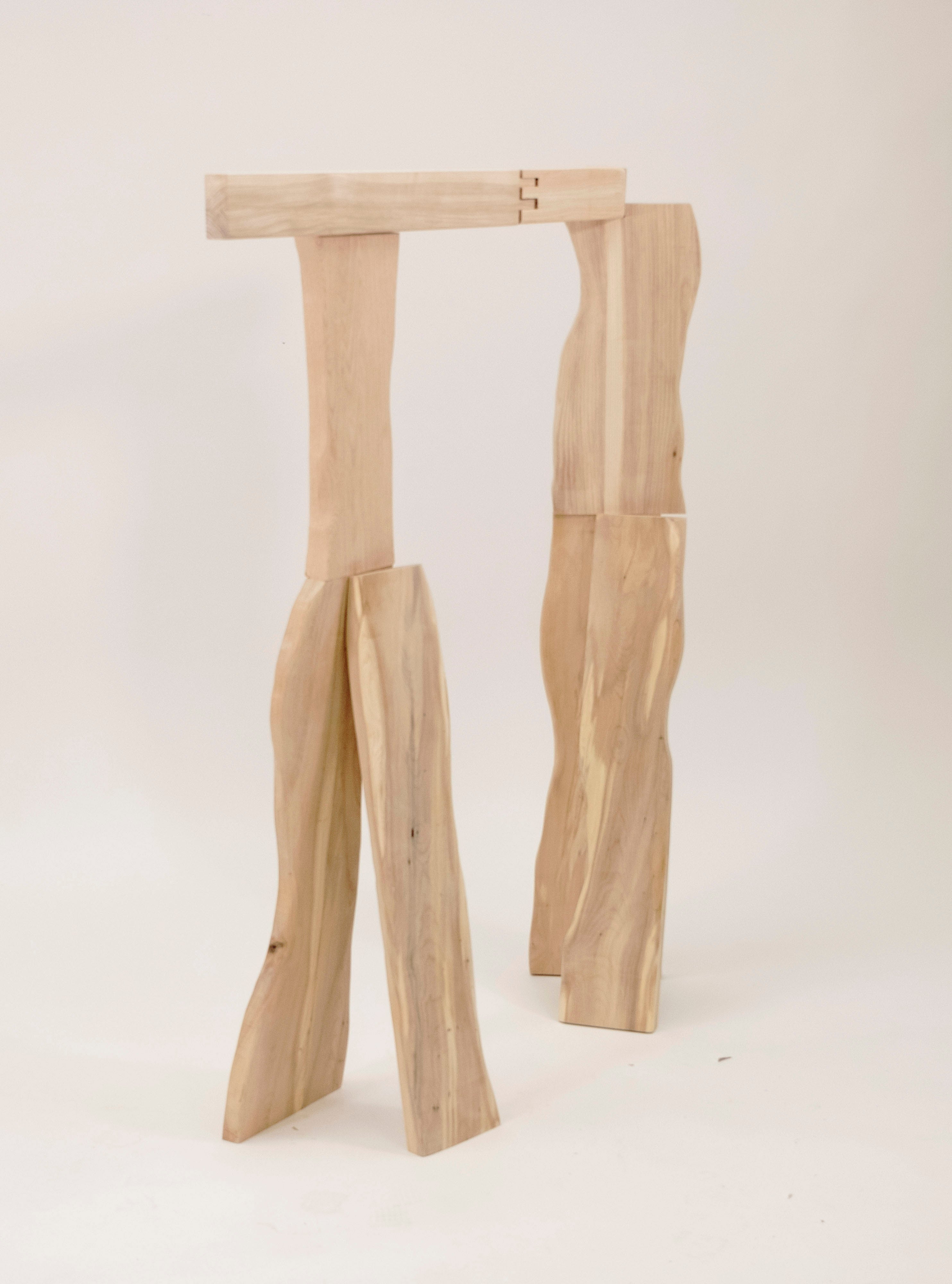 /A%20wooden%20coat%20rack%20inspired%20by%20the%20standing%20posture%20of%20a%20person%20in%20a%20living%20room%2C%20made%20from%20three%20different%20types%20of%20wood.