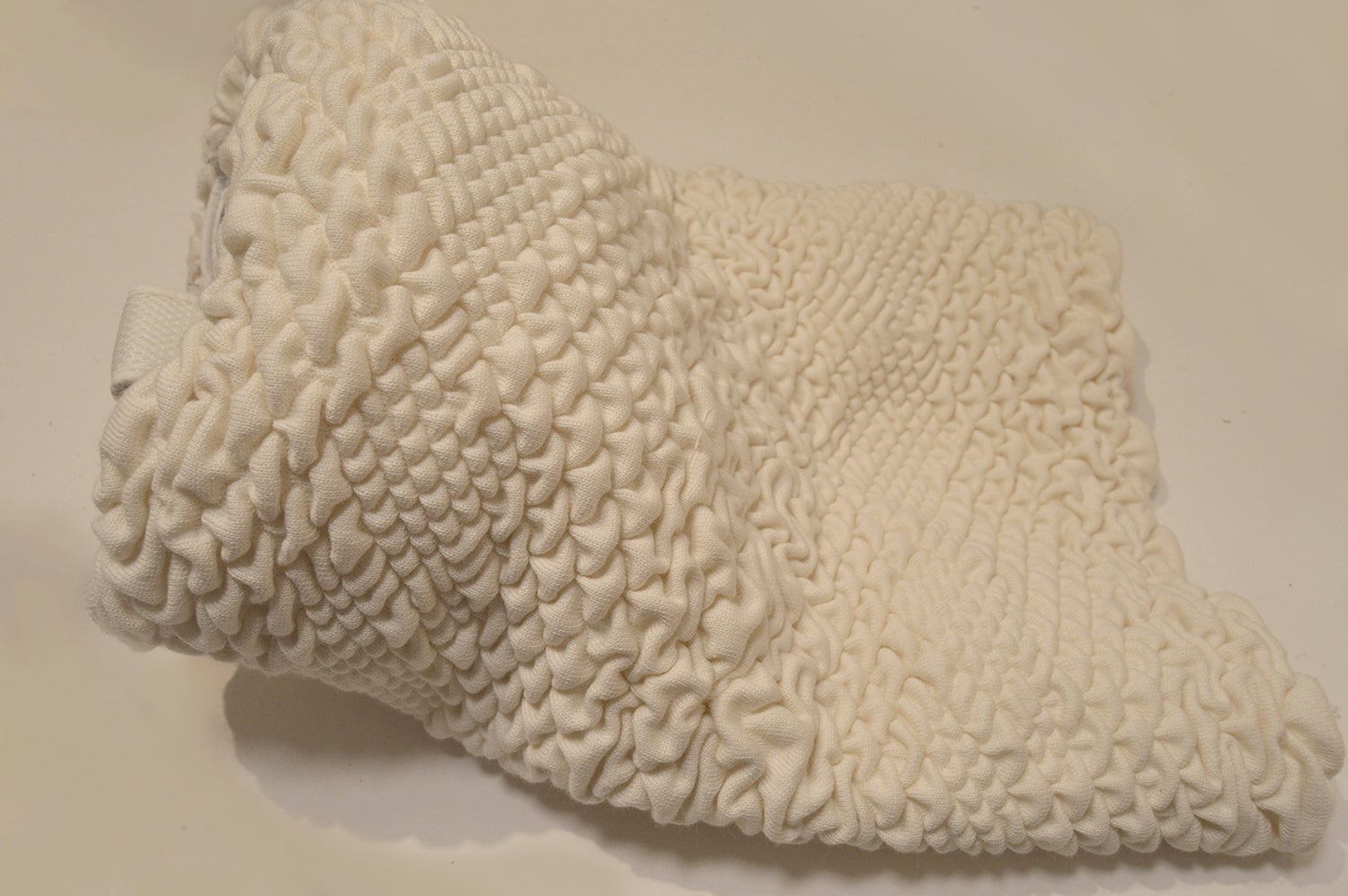 /A%20knitted%20helmet%20accessory%2C%20inspired%20by%20the%20VR%20headset%20but%20alternatively%20covering%20vision%20and%20hearing%20and%20instead%20allowing%20for%20the%20wearer%20to%20be%20immered%20in%20the%20haptics.