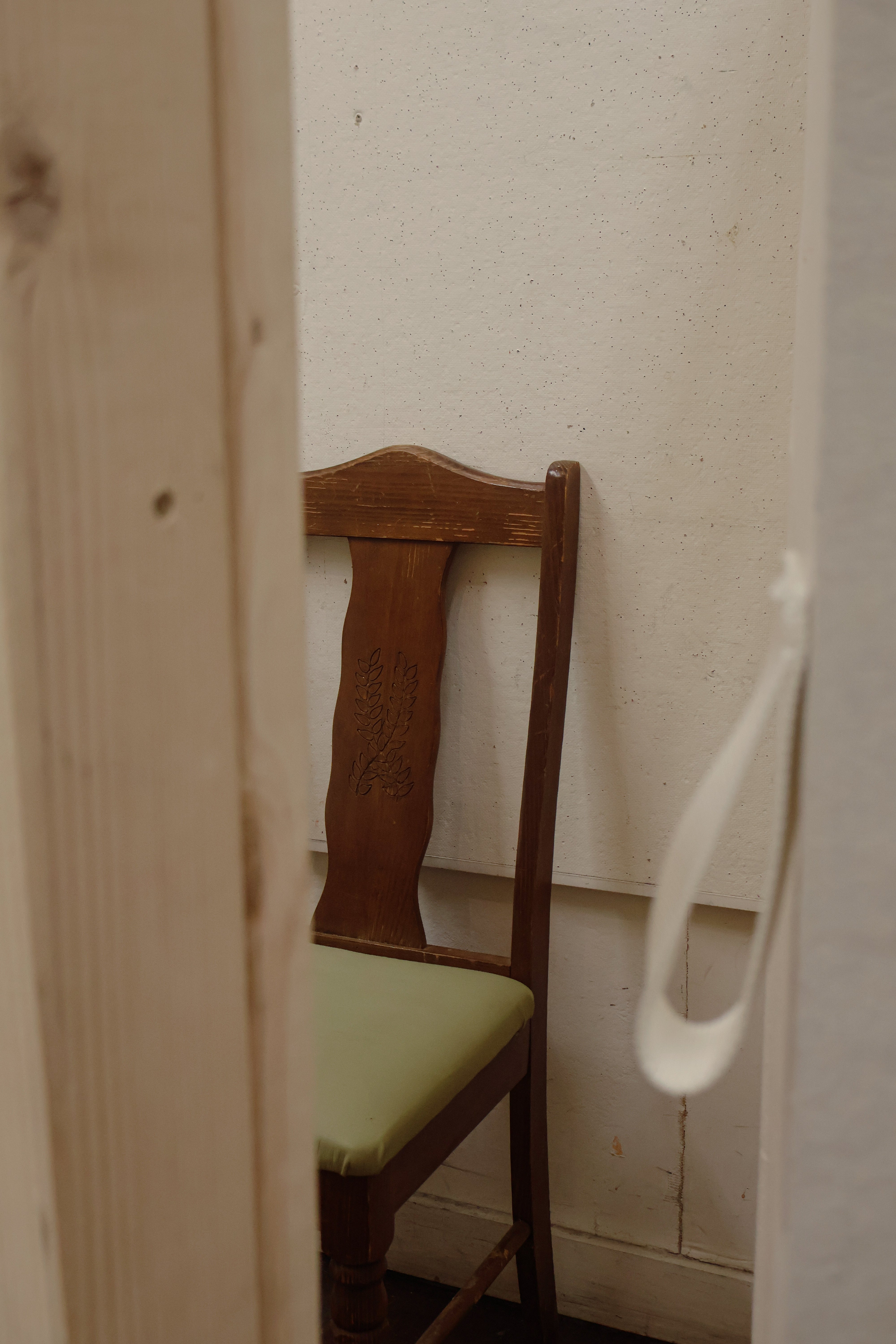 /Closely%20cropped%20image%20through%20a%20slightly%20open%20door%20into%20the%20seat%20in%20the%20booth