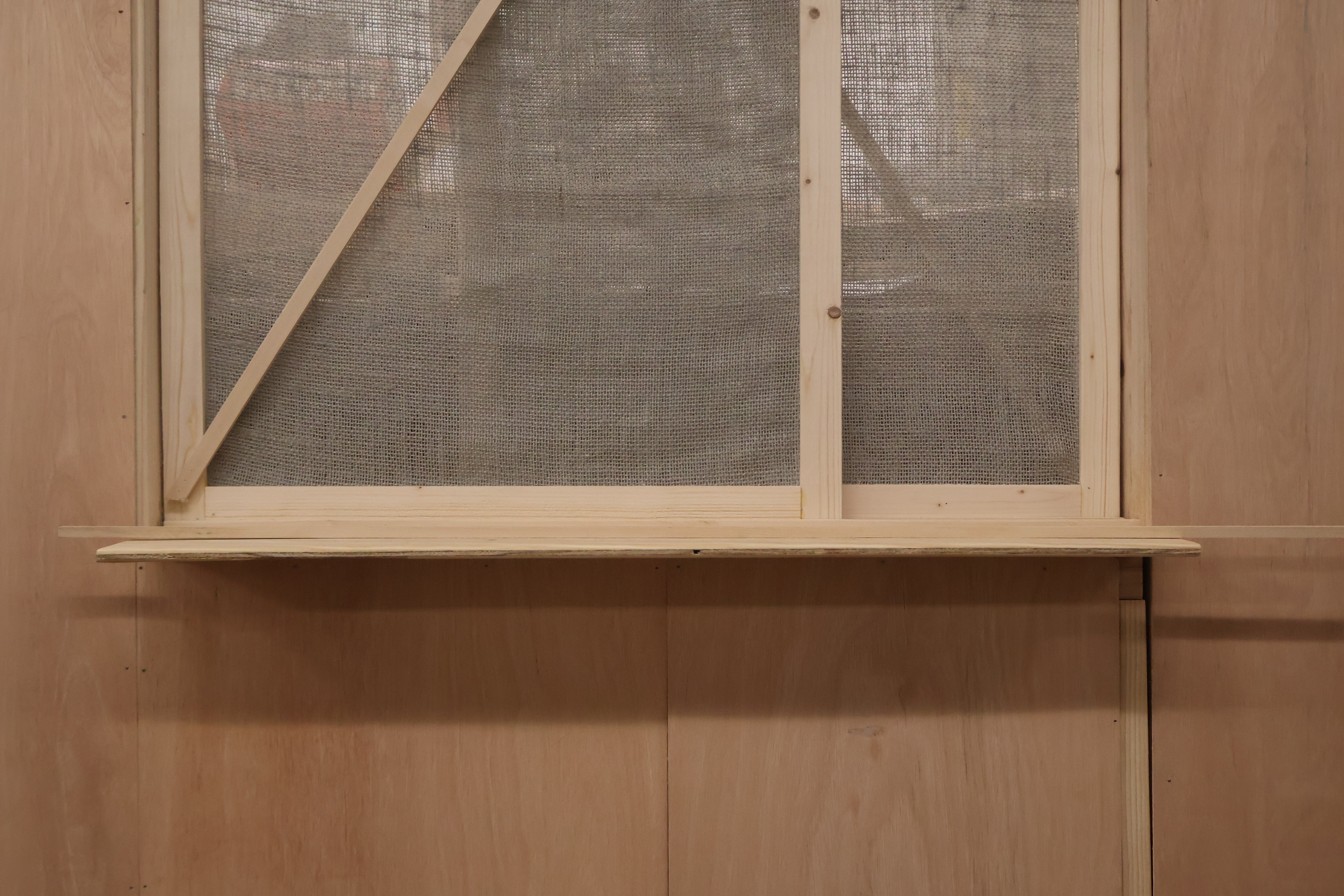 /Close-Up%20View%20of%20the%20dividing%20screen%20between%20the%20two%20sides%20of%20the%20booth%20-%20made%20from%20Burlap%20and%20Wood