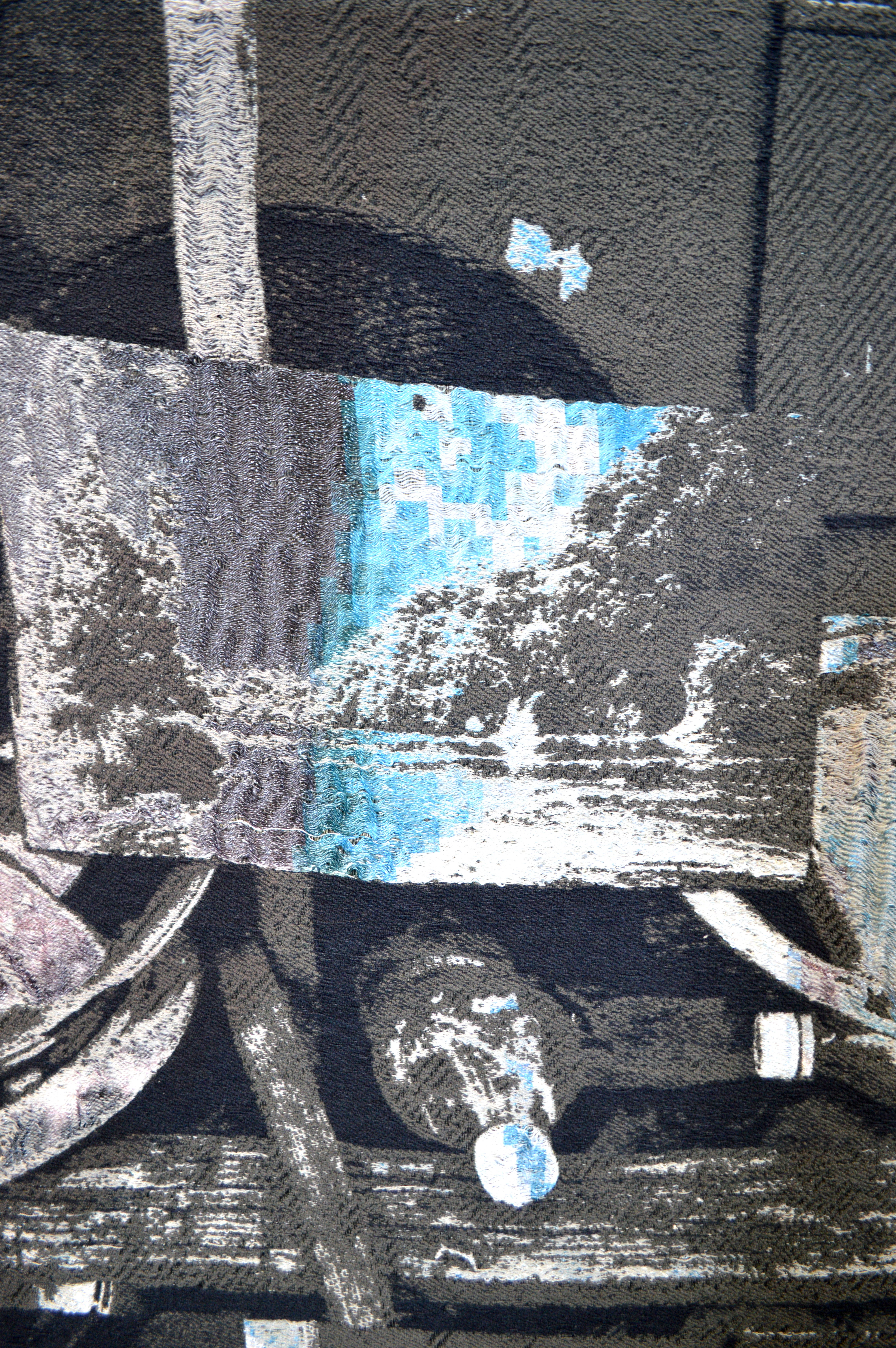 /An%20image%20depicting%20a%20close%20up%20of%20a%20weaving.%20The%20close%20up%20shows%20one%20repeat%20of%20a%20larger%20work%20with%20a%20landscape%20and%20a%20plastic%20bottle%20in%20a%20greyscale%20color%20palette.
