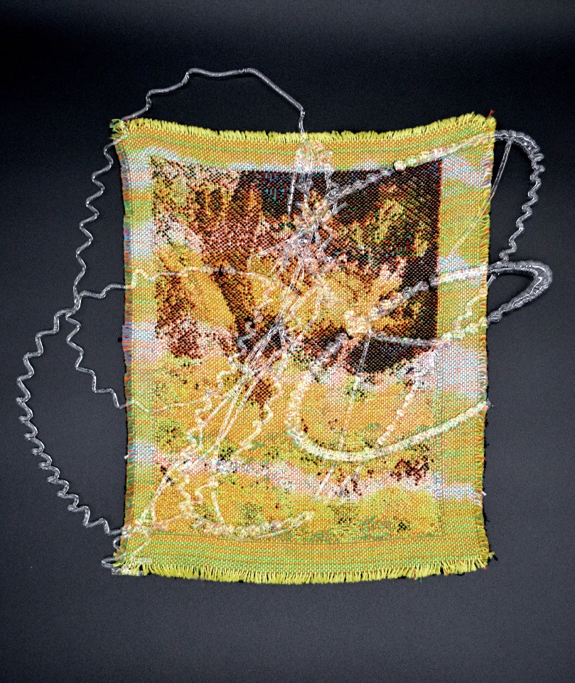 /A%20small-scale%20yellow%20abstract%20weaving%20placed%20on%20a%20black%20background%20with%20a%20thin%20and%20swirly%20glass%20layer%20on%20top.