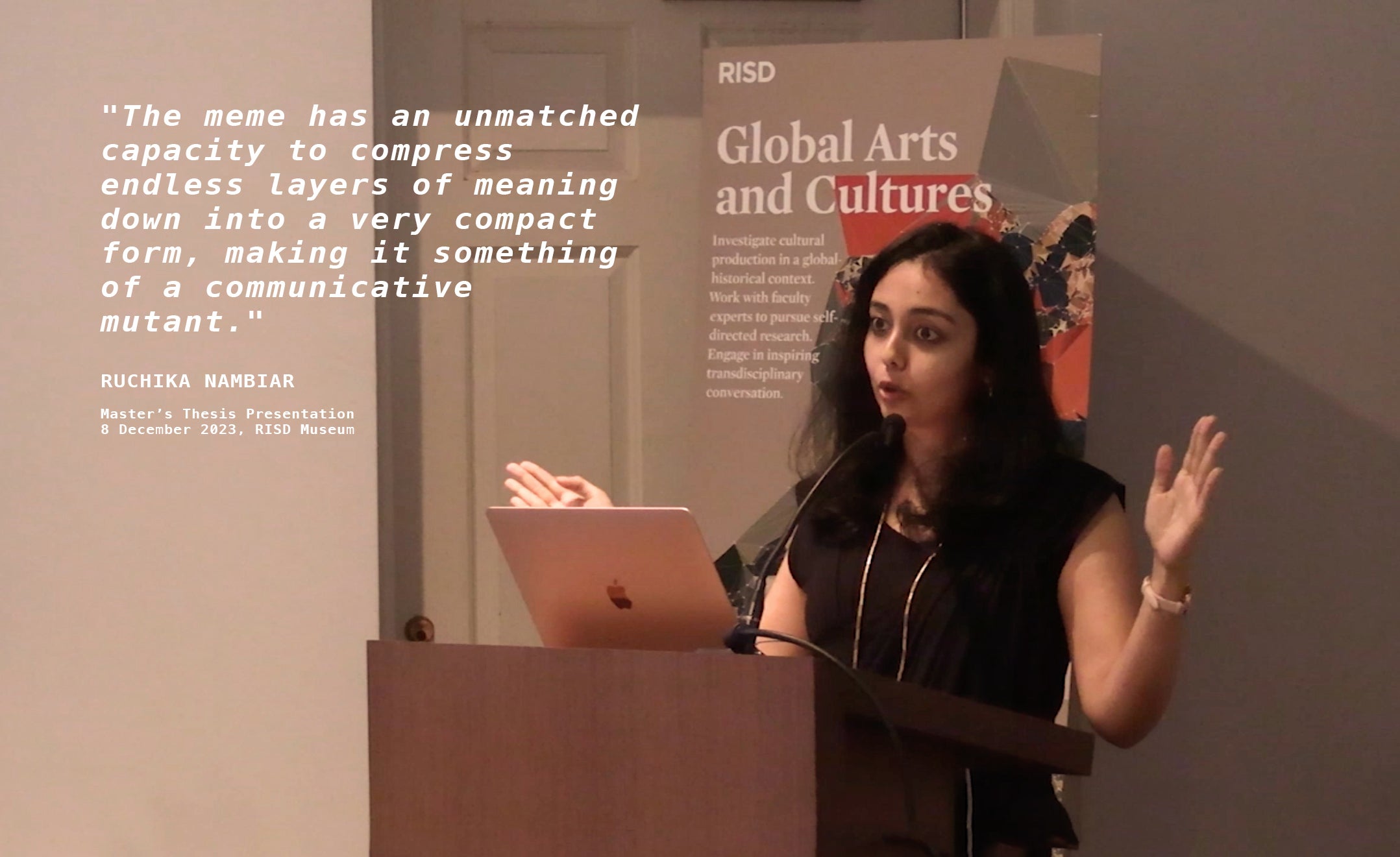 Ruchika Nambiar standing at a podium and speaking into a mic, along with a corresponding slideshow playing on the side.