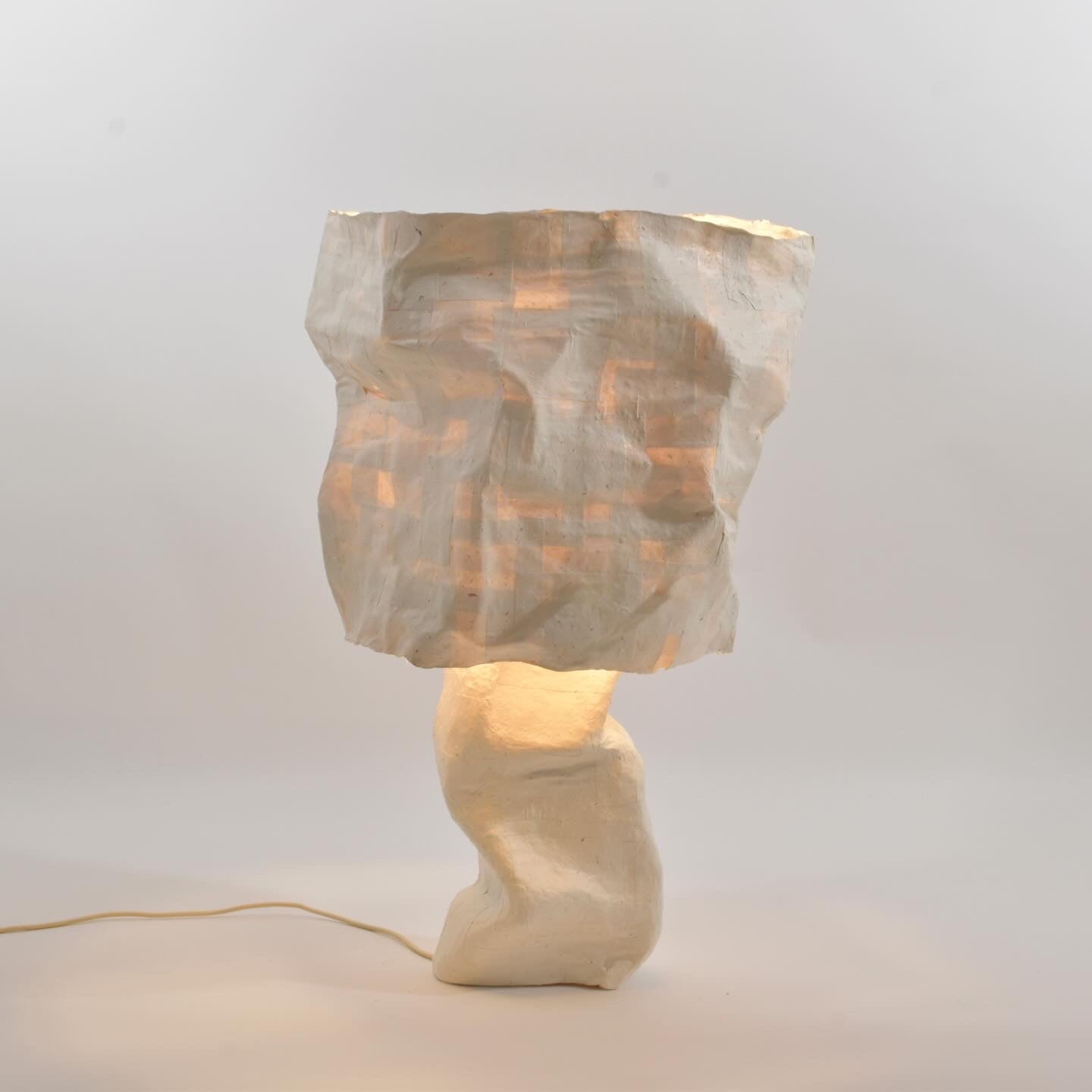 /this%20chair%20has%20an%20architectural%20grid%20form%20wrapped%20in%20brown%20kraft%20paper