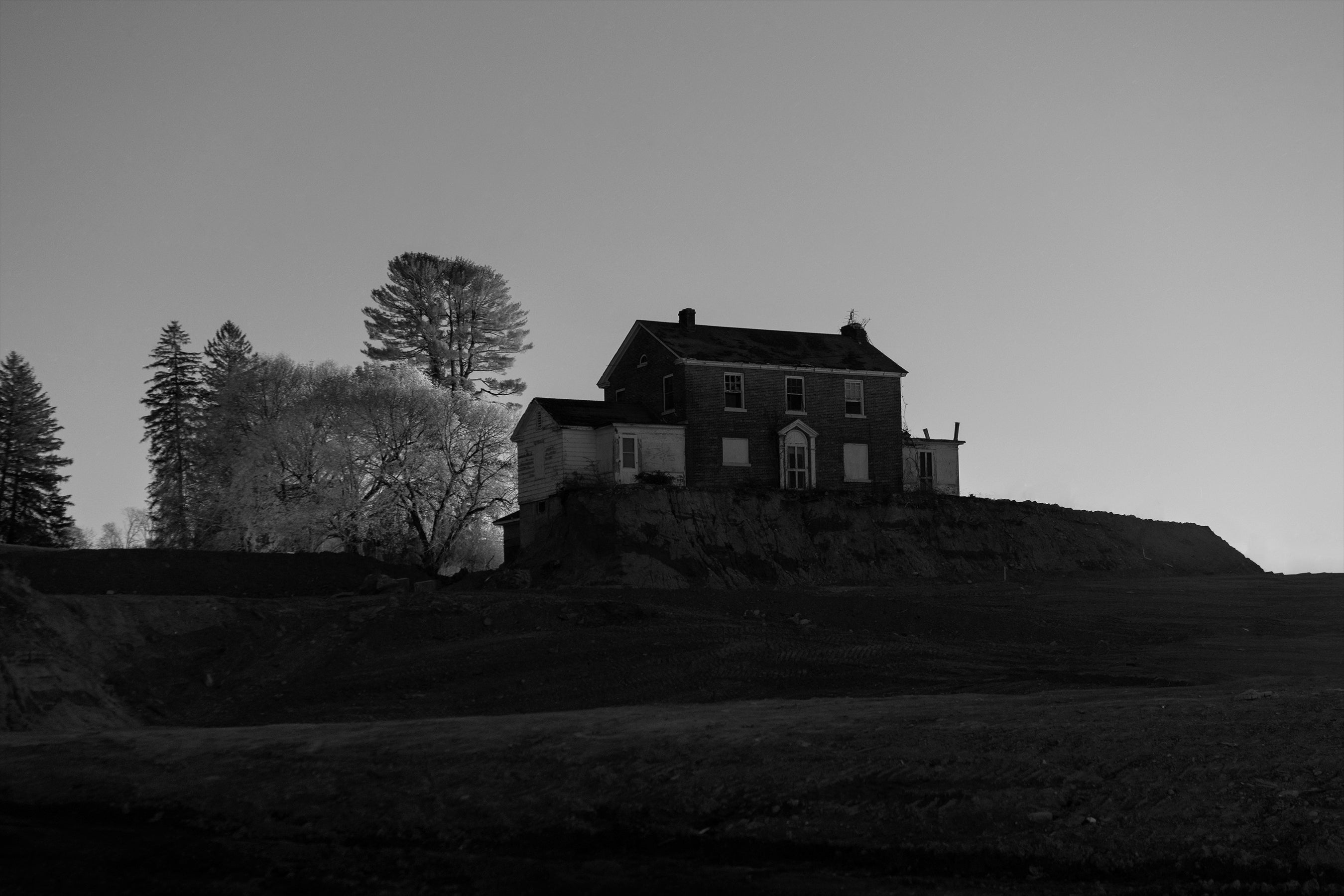 /An%20old%20abandoned%20house%20surrounded%20by%20a%20dug%20out%20constuction%20site