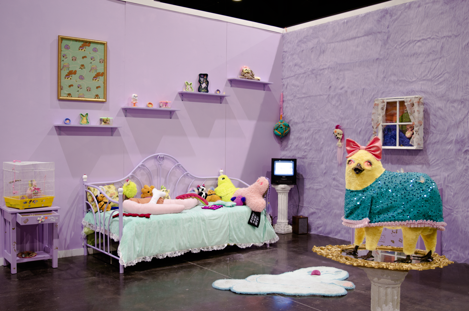 /Photograph%20of%20an%20installation%20of%20a%20fantasy%20bedroom.%20%20There%20is%20a%20bed%20covered%20with%20toys%2C%20a%20TV%20in%20the%20corner%20playing%20a%20reel%20of%20chaotic%20videos%2C%20and%20sculpture%20of%20a%20duck/horse%20chimera.%20%20
