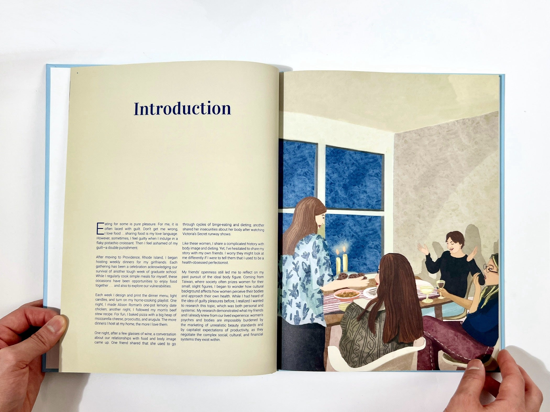 /A%20photograph%20of%20the%20spread%20of%20the%20Introduction%20Page%20featuring%20an%20illustration%20of%20a%20home%20dinner%20scene%20on%20the%20right%20side%20and%20text%20on%20the%20left%20page.