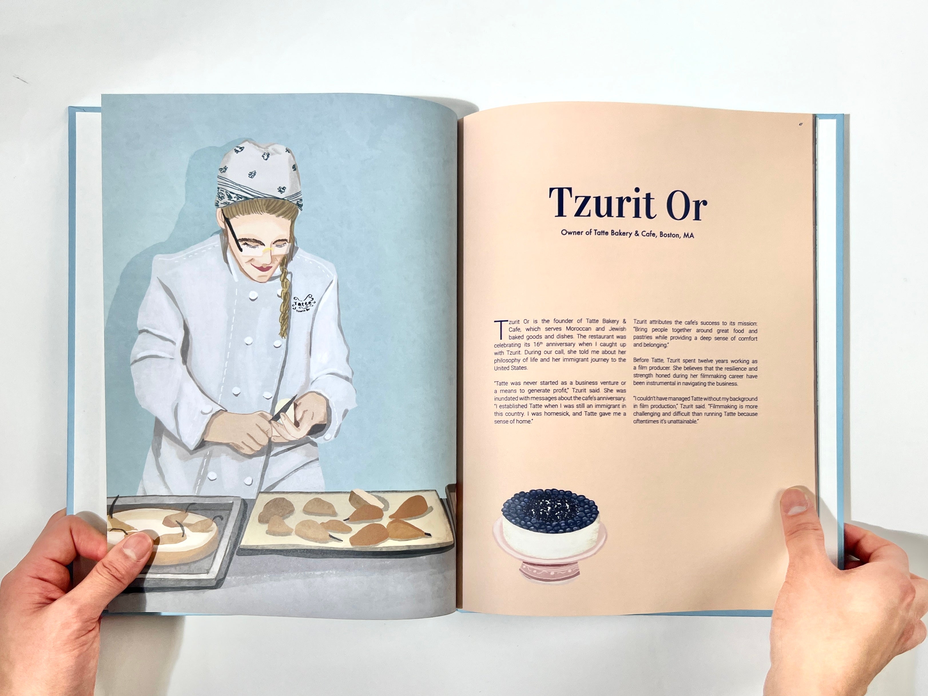 /A%20photograph%20of%20a%20book%20spread%20featuring%20an%20illustrated%20woman%20pastry%20chef%20on%20the%20left%20page%2C%20and%20an%20interview%20profile%20of%20the%20owner%20of%20Tatte%20Bakery