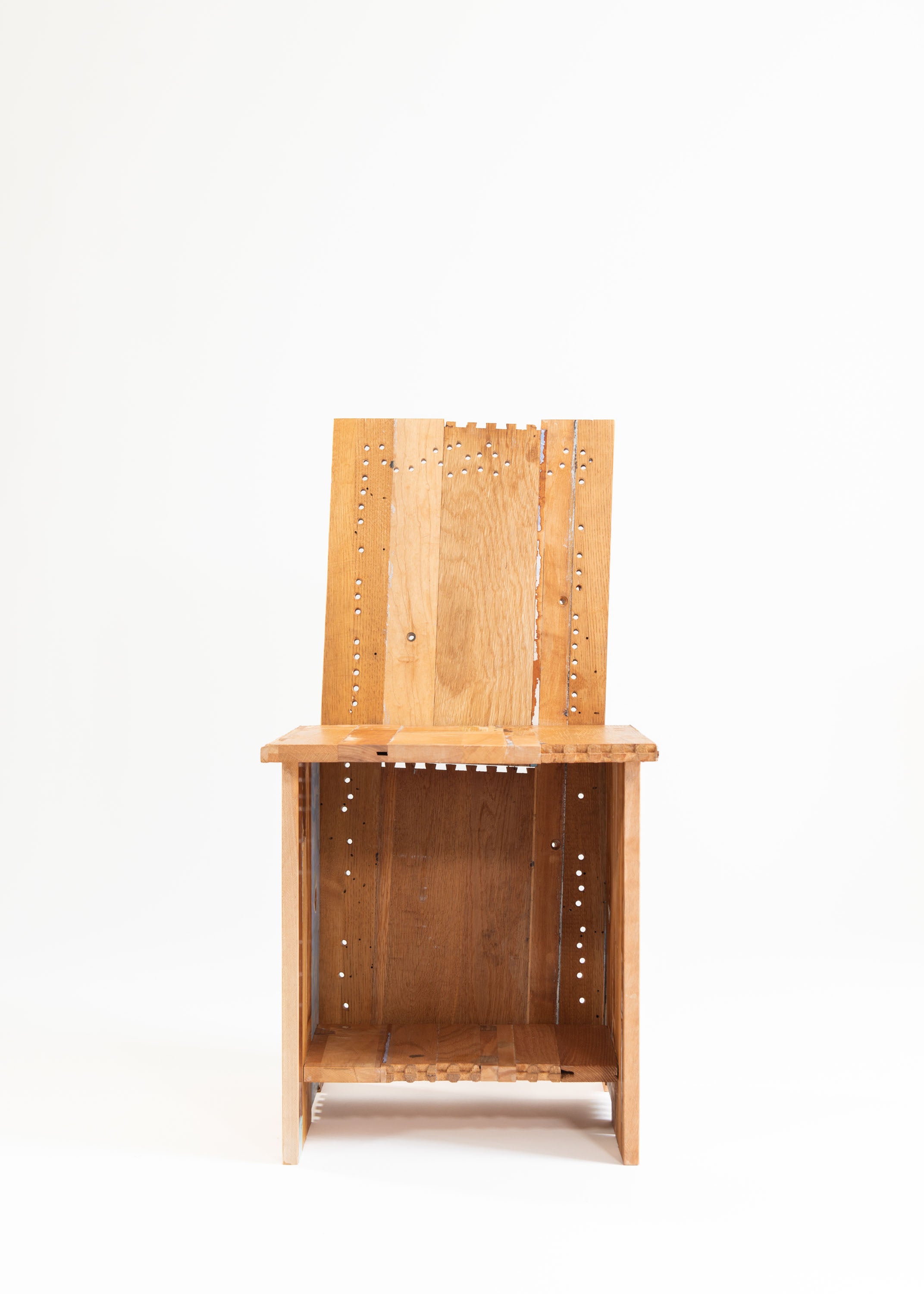 /A%20chair%20made%20from%20the%20deconstructed%20materials%20of%20a%20found%20dresser%20painted%20in%20multiple%20colors.