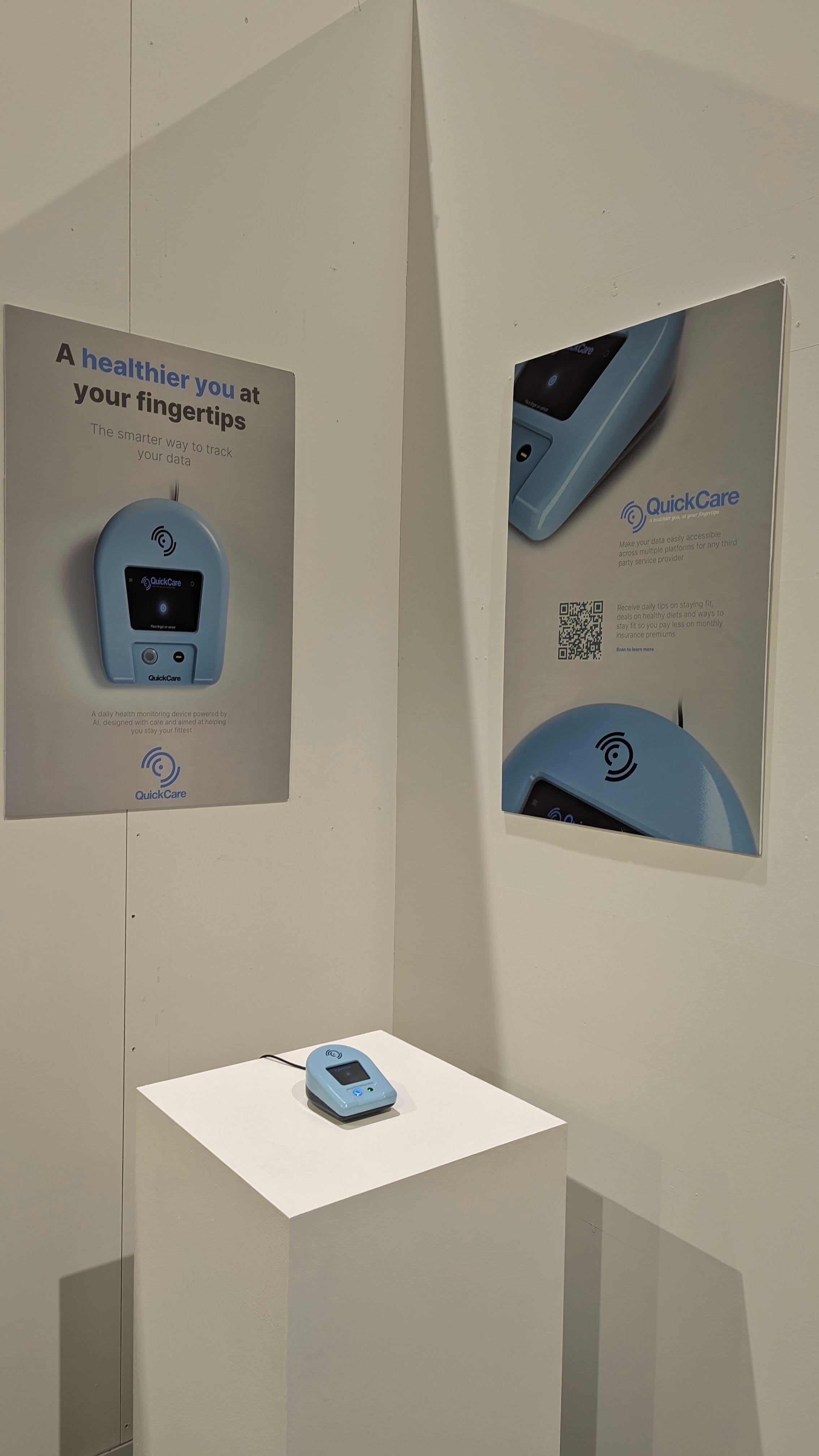 QuickCare product on pedestal placed in a corner between two promotional product posters. One poster has a QR that leads to an online product page.