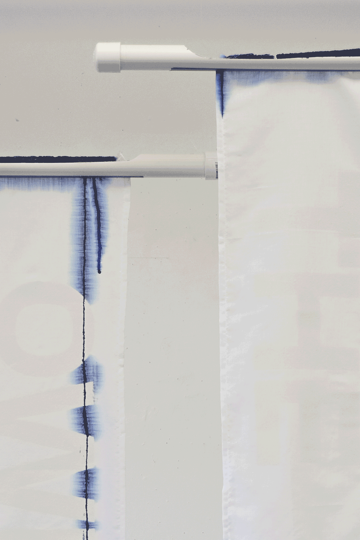 Ice frozen with indigo melting over fabric panels to reveal message, 'WHO OWNS THE ARCTIC'