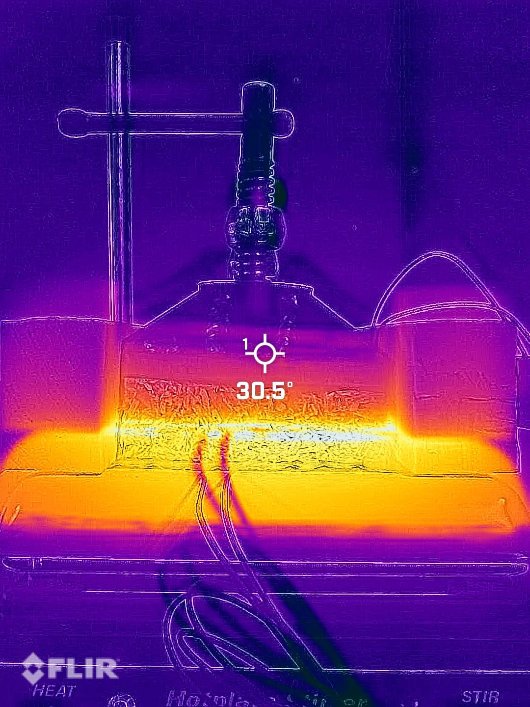 An infrared photograph of a thermal conduction test on a Japanese Knotweed composite block showing a temperature gradient.