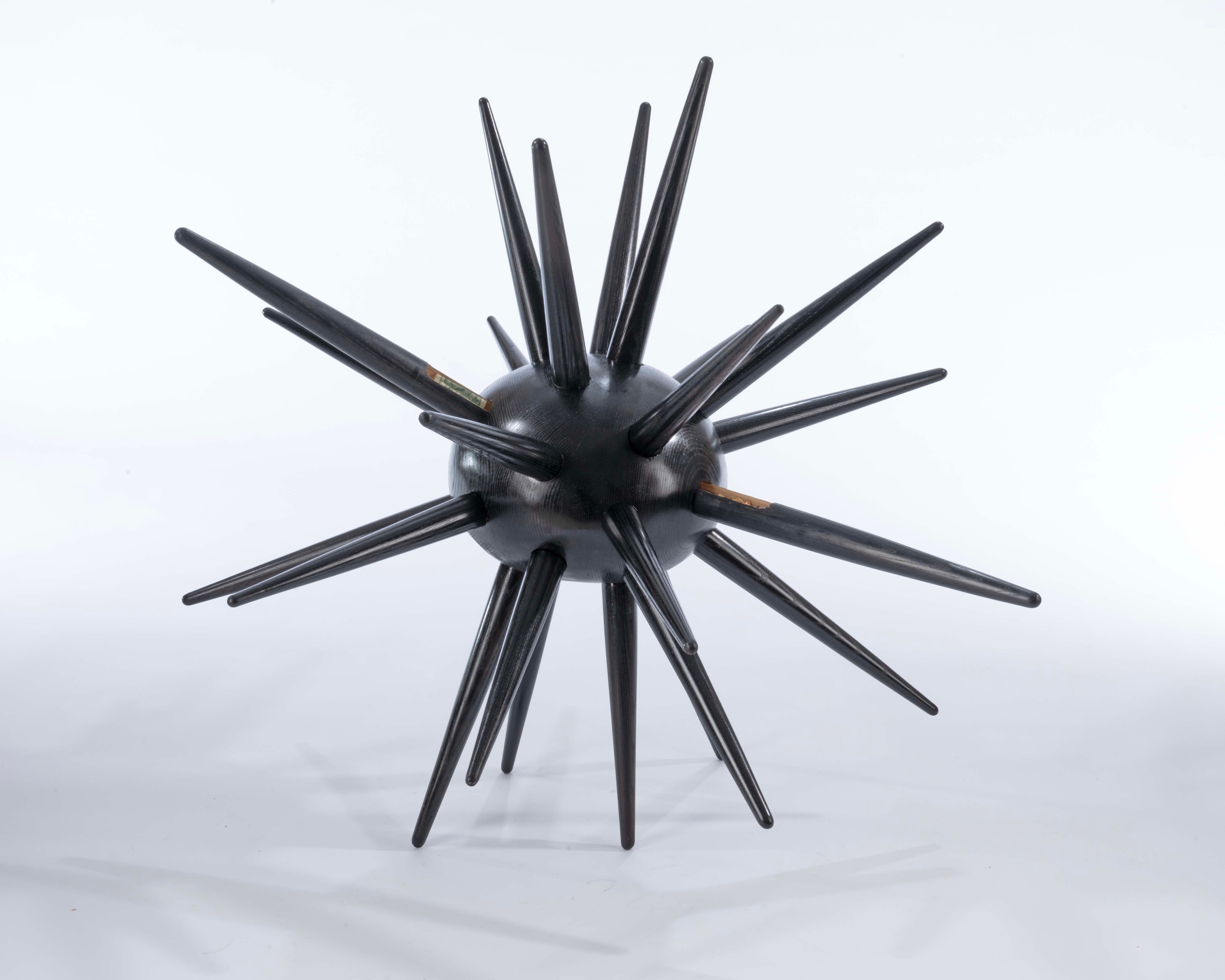 Urchin is a spiked ash wood cabinet with hidden drawers, symbolizing self-protection and inner vulnerability.