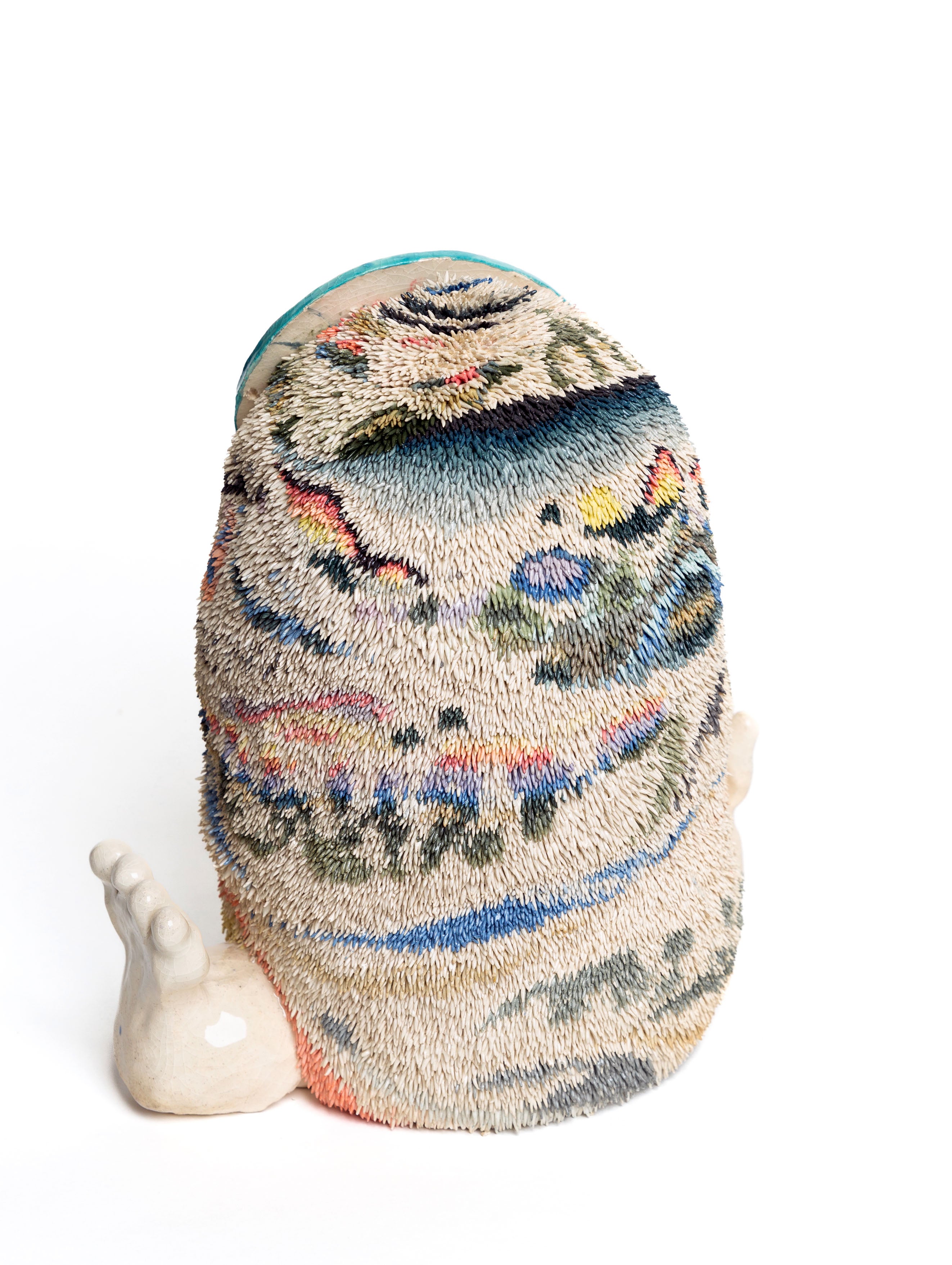 This is an image of the back of a furry creature- the fur is made of stained clay, and therefore has colorful patterns.
