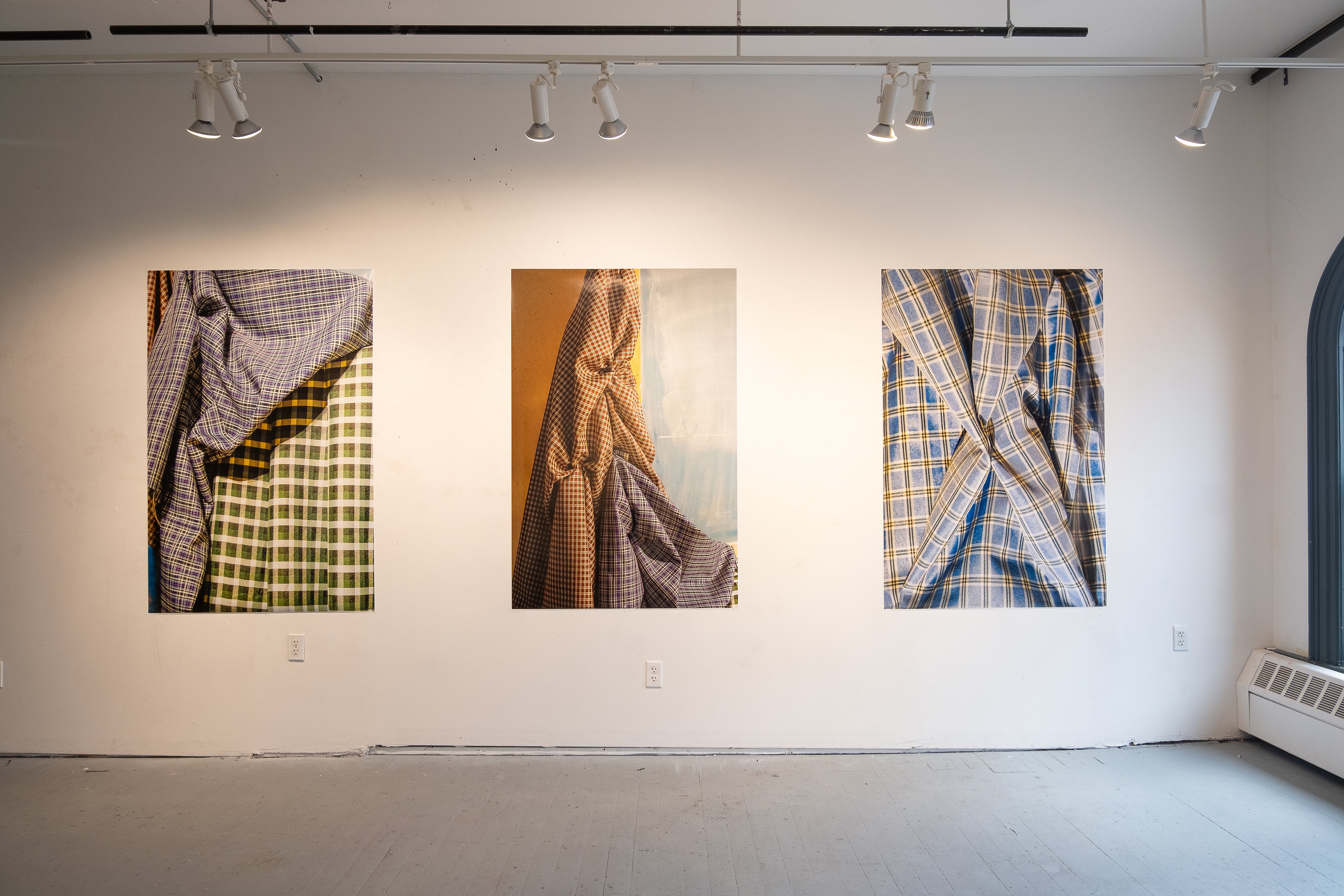 three works in a gallery