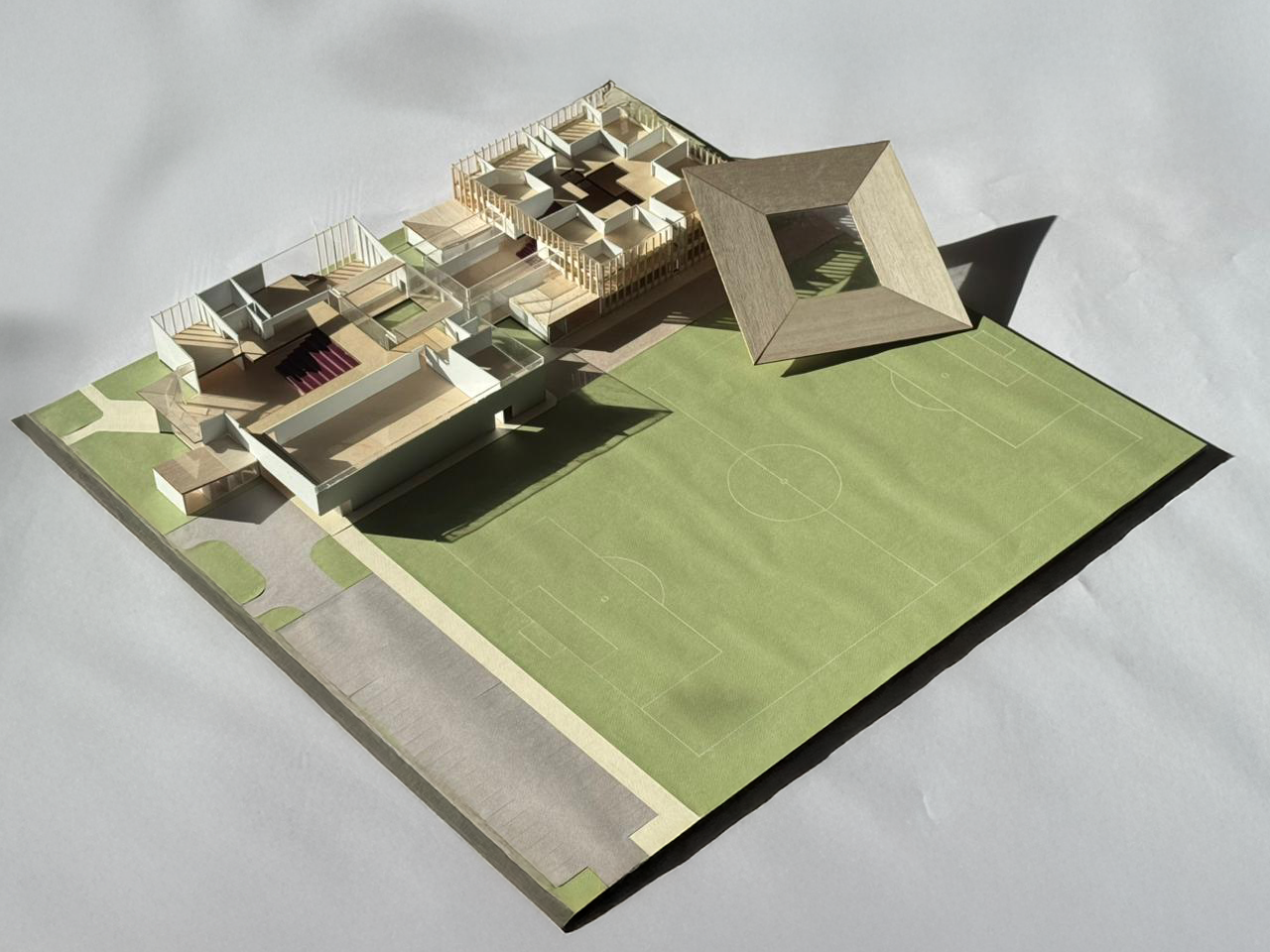Model of the school with surrounding context. Roof is removable to show interior spaces.