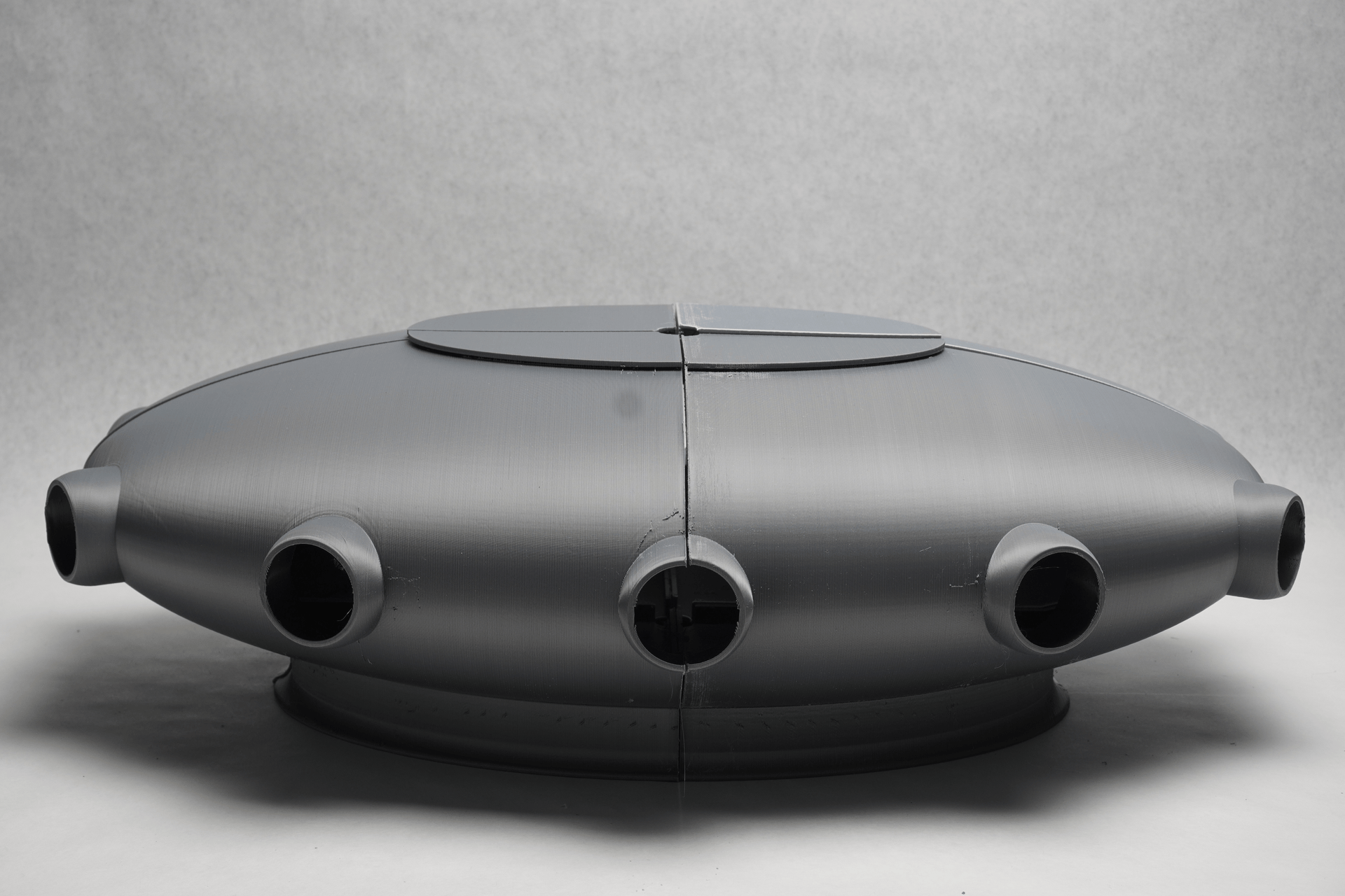The circular opening where covered with plastic balls and holographic sheets to bring in a sense of mystery. The form was drafted on Rhino and 3D printed in 4 parts