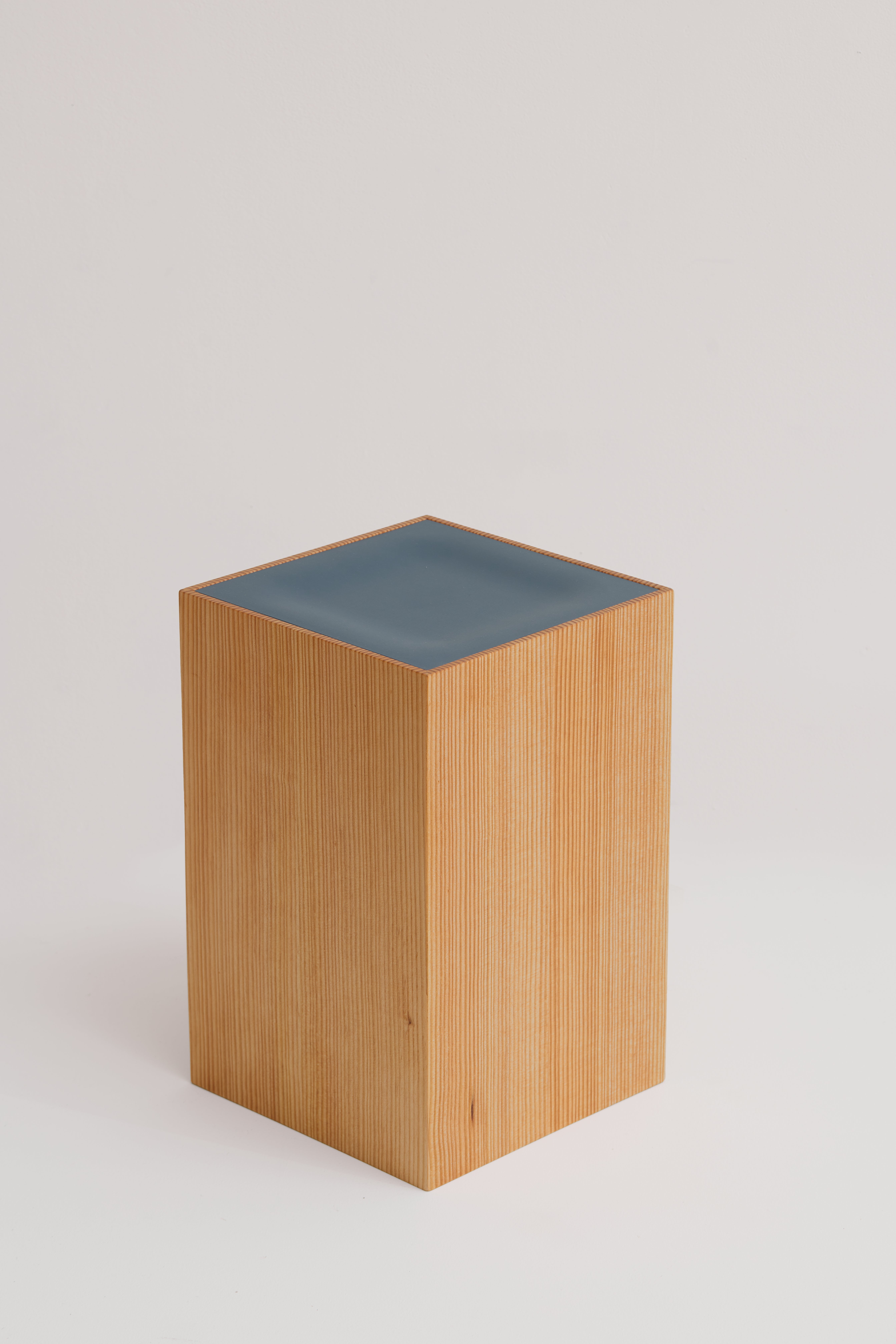 Box stool with subtle impression at center